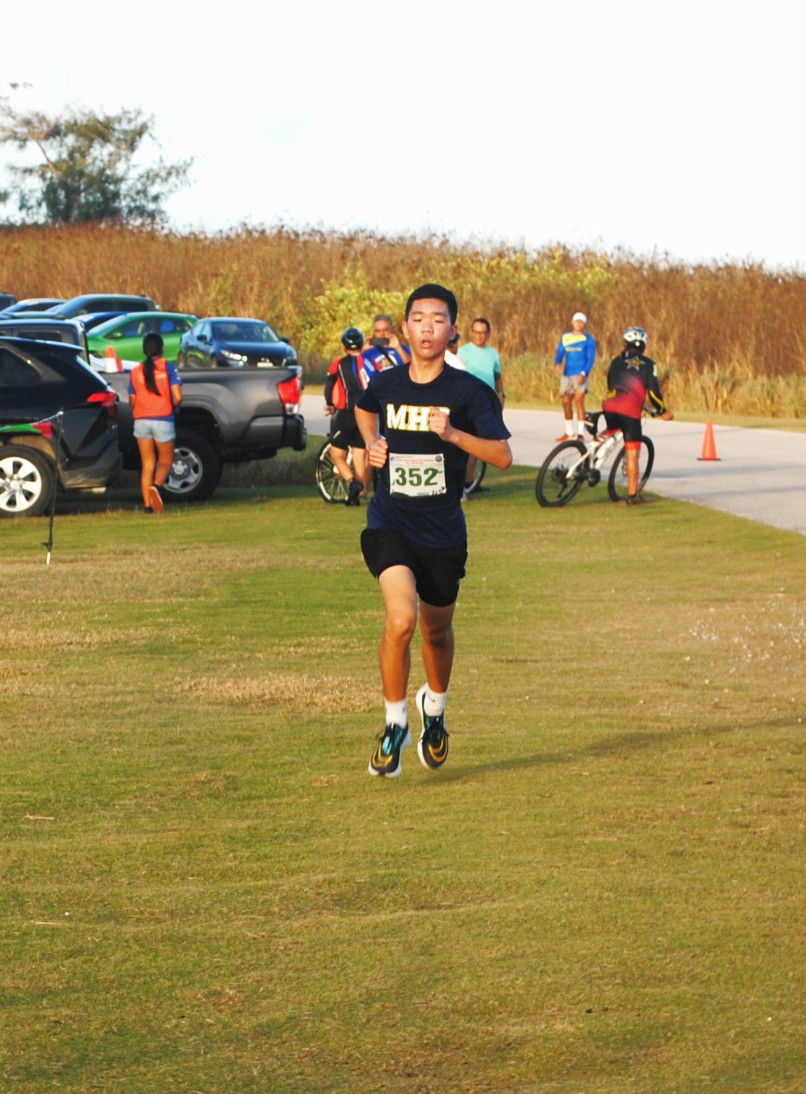 Pony Tang pushes through for the finish during the AK 5.5K Fun Run Saturday at  Banzai Cliff.