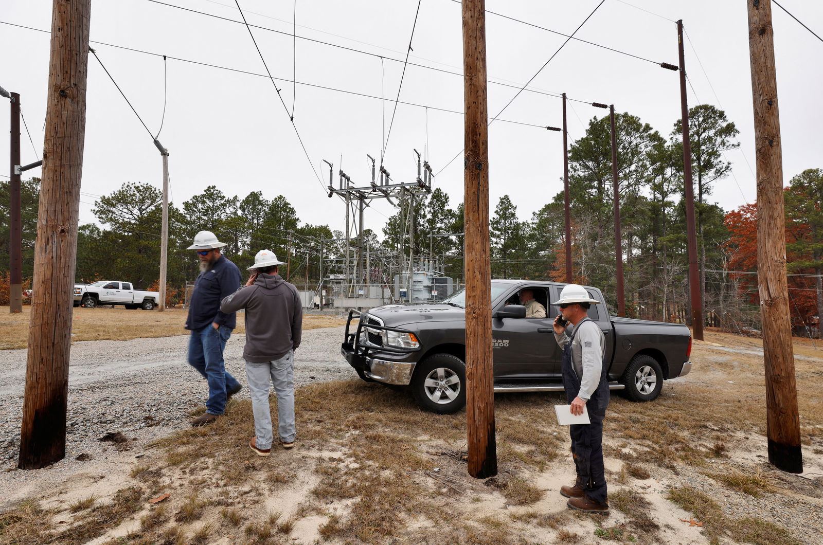 Duke Energy workers gather as they plan how to repair a crippled electrical substation that they said was hit by gunfire after the Moore County Sheriff said that vandalism caused a mass power outage, in Carthage, North Carolina, Dec. 4, 2022.