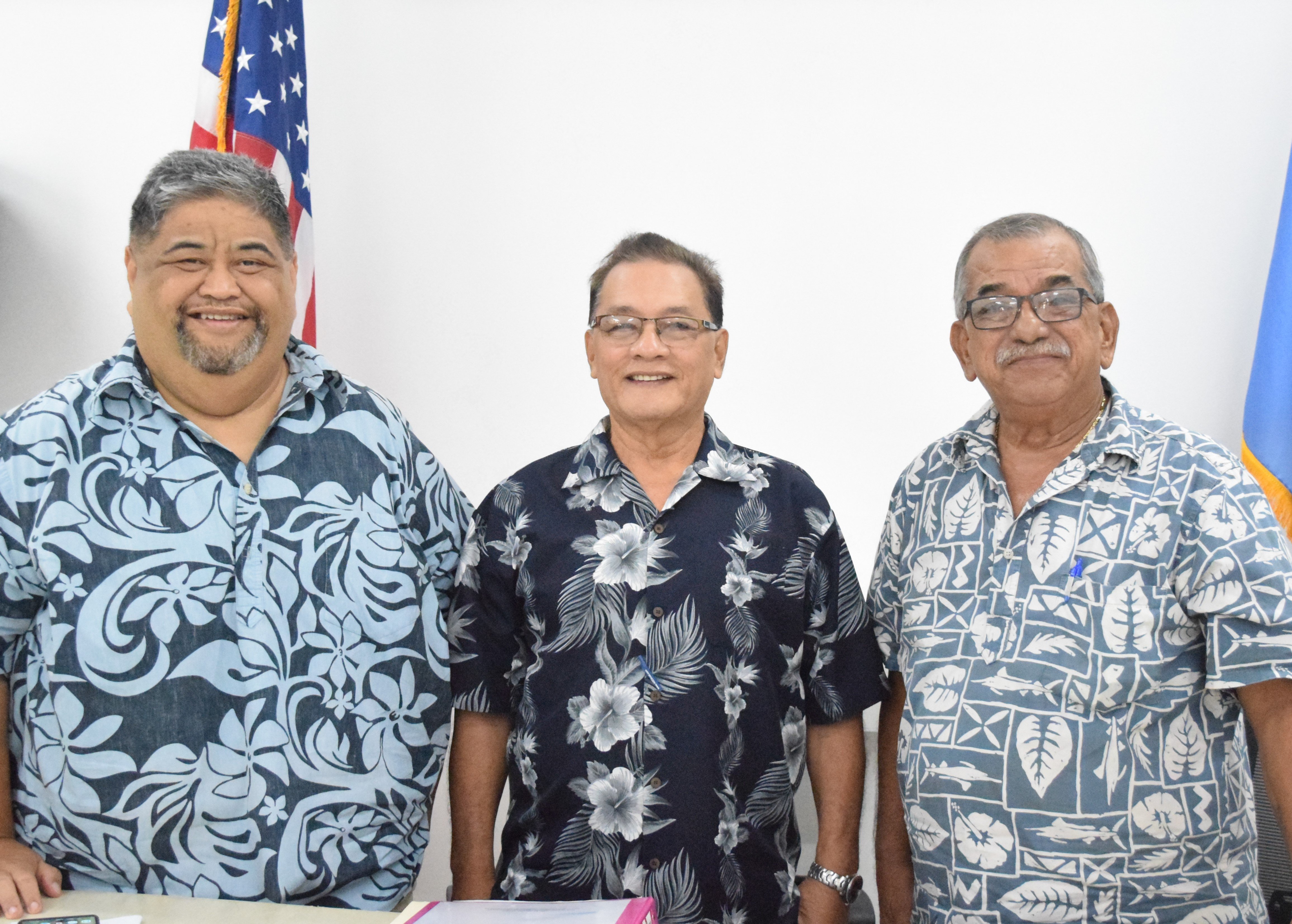 Transition and Inauguration Committee overall chairman John "Liling" S. Reyes, center, with transition subcommittee chairman Claudio Norita, left, and inauguration subcommittee chairman Oscar M. Babauta pose for a photo after a press conference Monday at the committee's headquarters on Beach Road in Susupe.