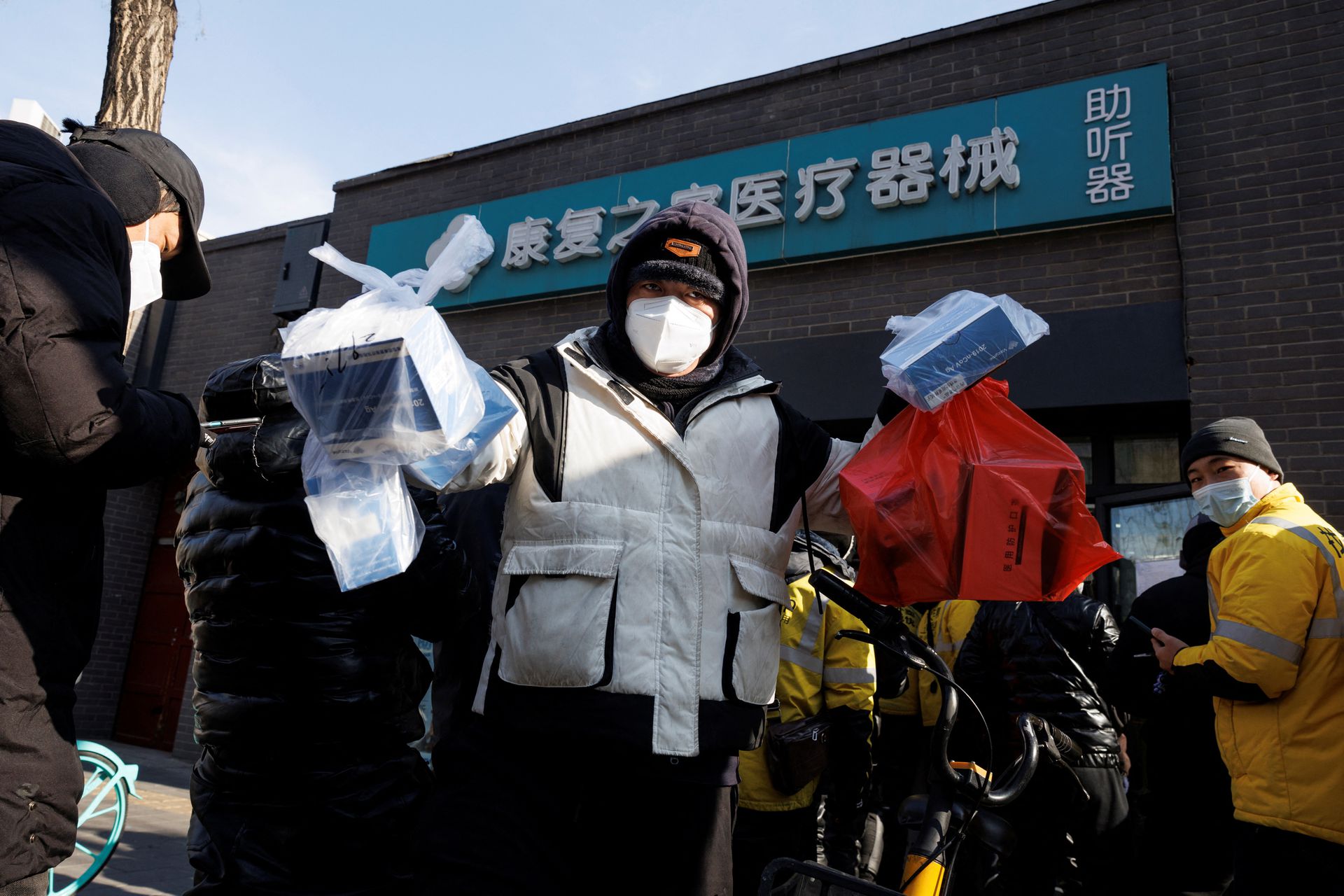A delivery driver picks up medicine from a pharmacy in Beijing, Dec. 7, 2022.