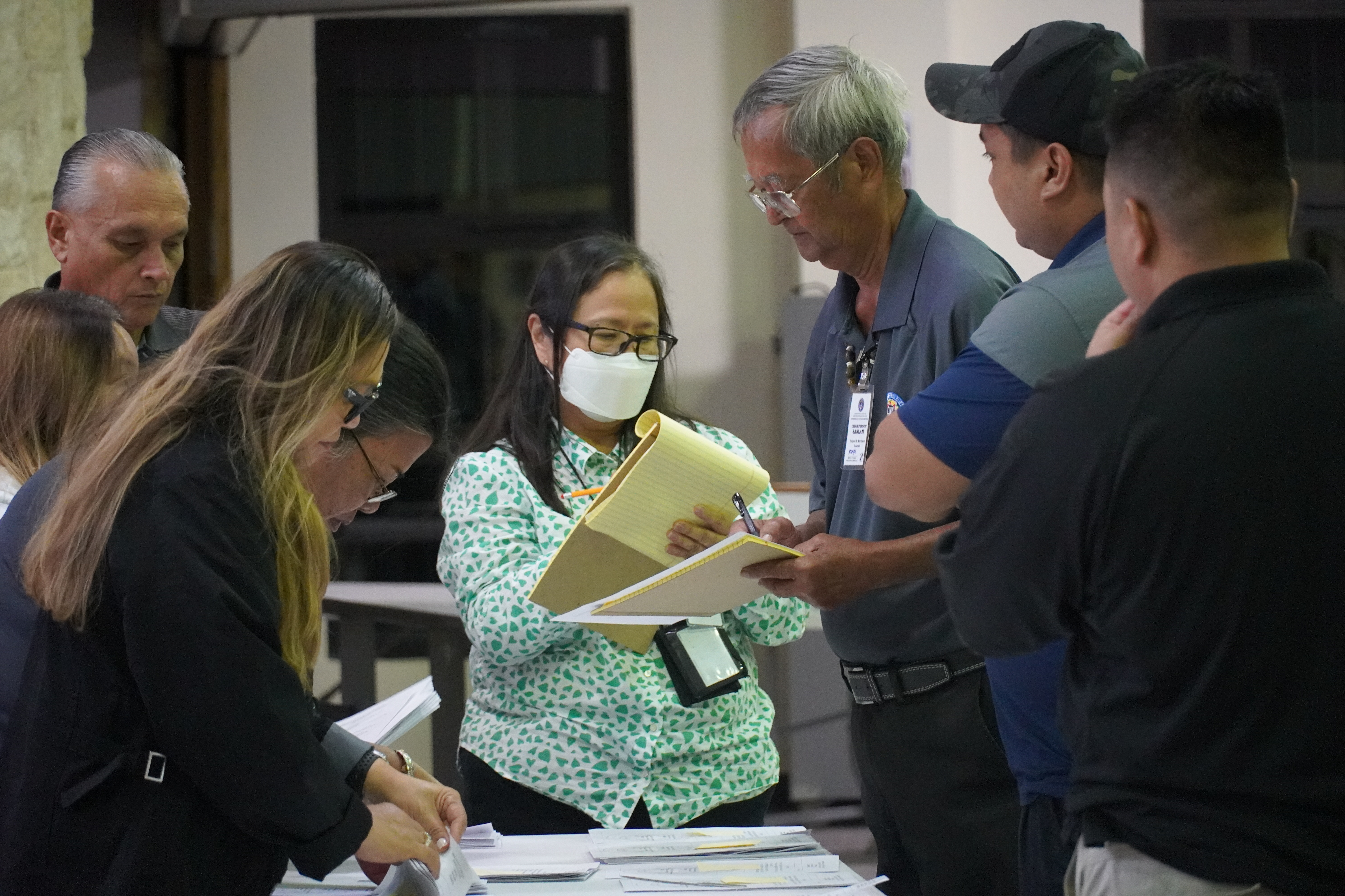 Election commissioners and Deputy Attorney General Lillian A. Tenorio verify the final count.