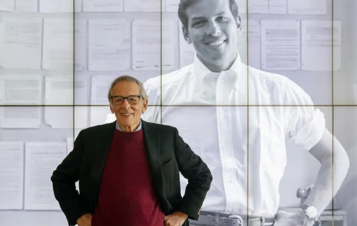 Author and biographer Robert Caro stands beside an image of his younger self after touring a permanent exhibit in his honor, "Turn Every Page": Inside the Robert A. Caro Archive, at the New York Historical Society Museum & Library in New York on Oct. 20, 2021.