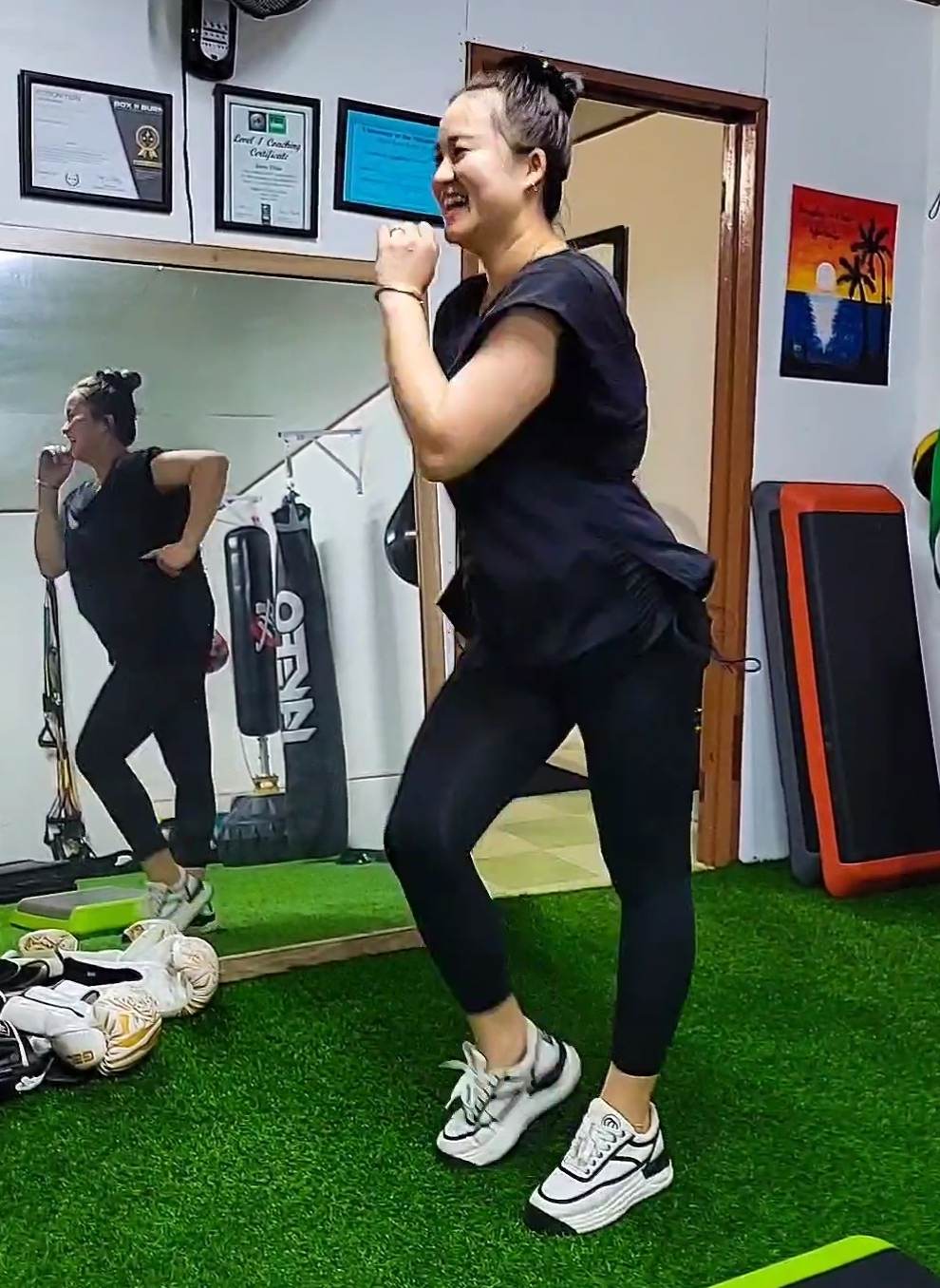 Li Li smiles as she works out at BBJ Athletics.