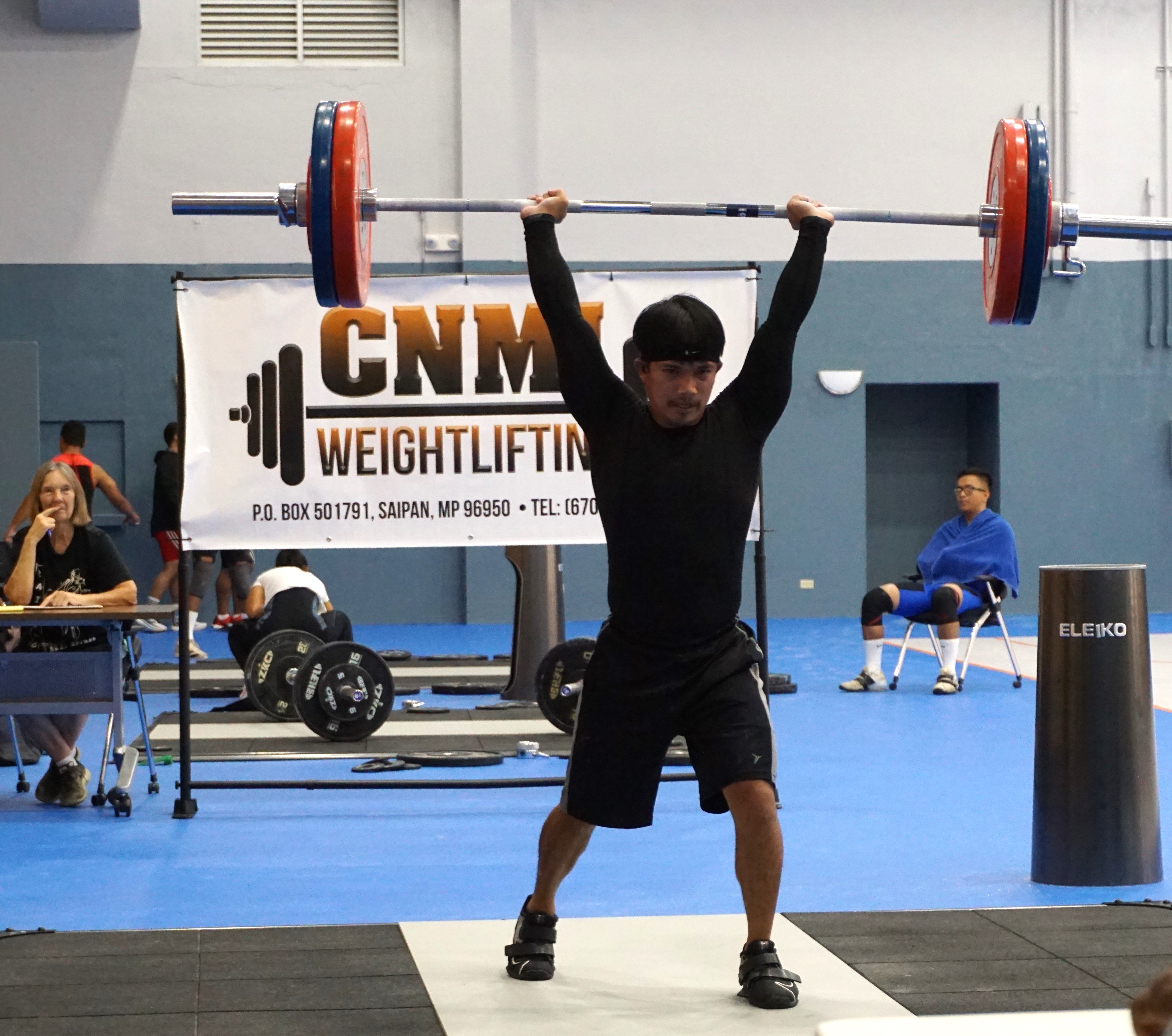 Ray Santos makes a successful lift in the clean & jerk portion of the CNMI Weightlifting qualifier event Saturday at the Ada gym.