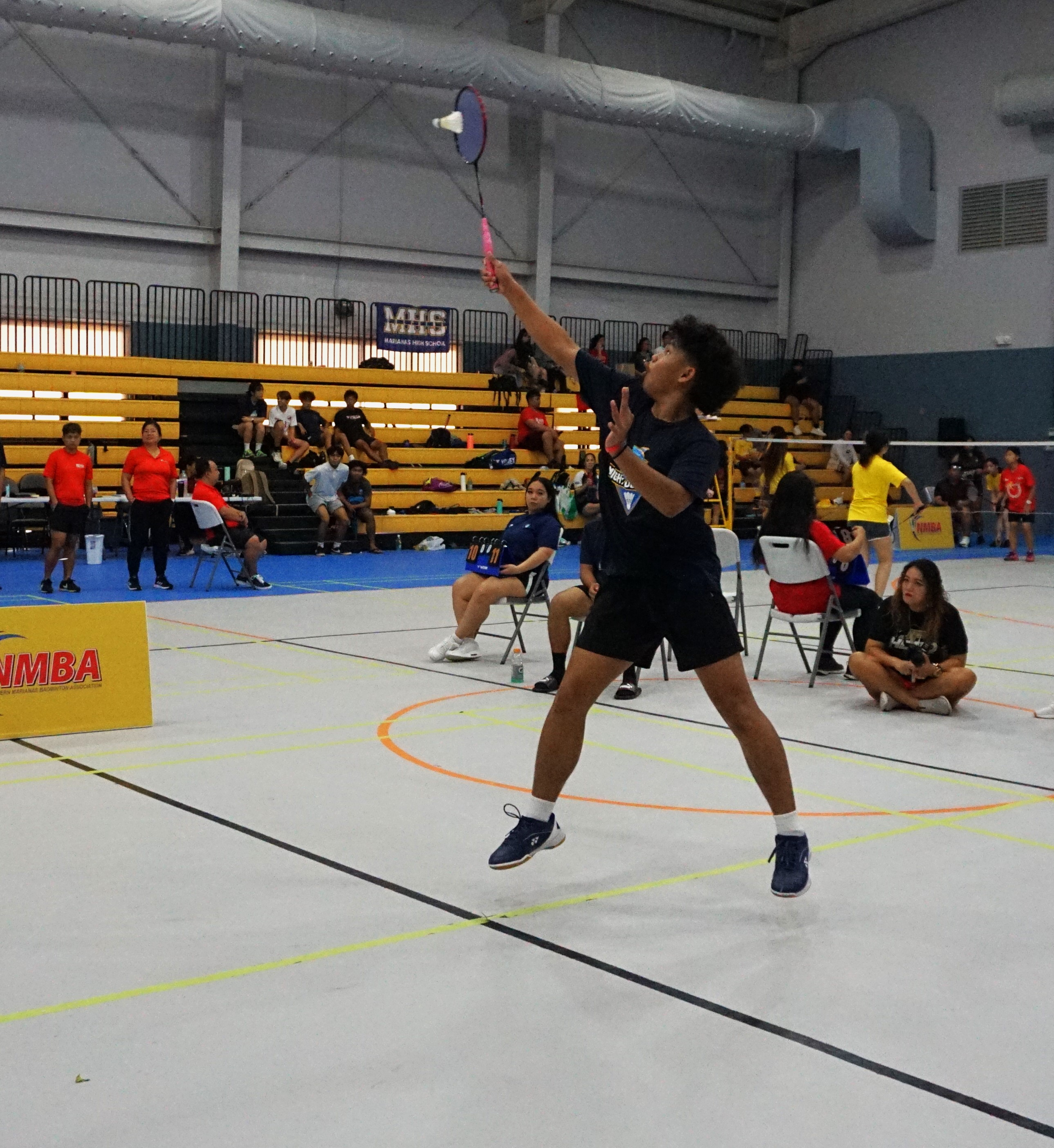 MHS 1's Brian Lubao extends for the overhead return during a boys singles event of the TakeCare-PSS Interscholastic Badminton League on Saturday at the Ada gym.