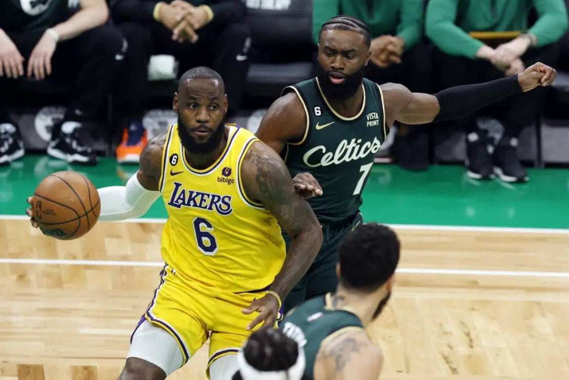 Los Angeles Lakers' LeBron James (6) drives for the basket in front of Boston Celtics' Jaylen Brown (7) during the first half of an NBA basketball game, Saturday, Jan. 28, 2023, in Boston.