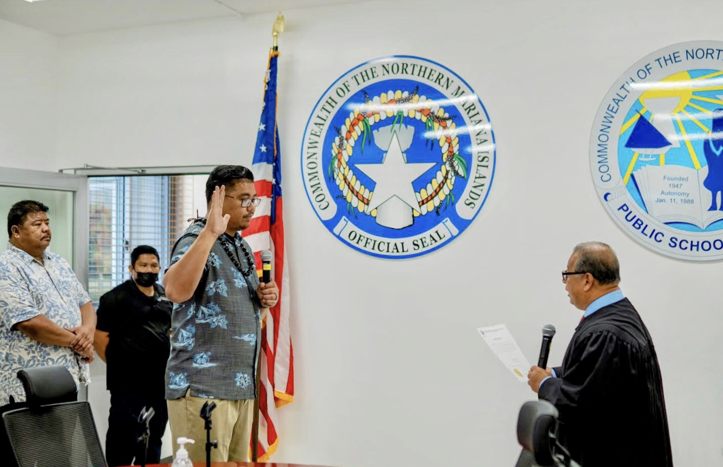 Board of Education Vice Chairman Antonio L. Borja of Tinian takes his oath of office before Supreme Court Justice Perry Inos Monday morning in the Board of Education conference room. Looking on is Borja’s father, former Rep. Antonio SN Borja.