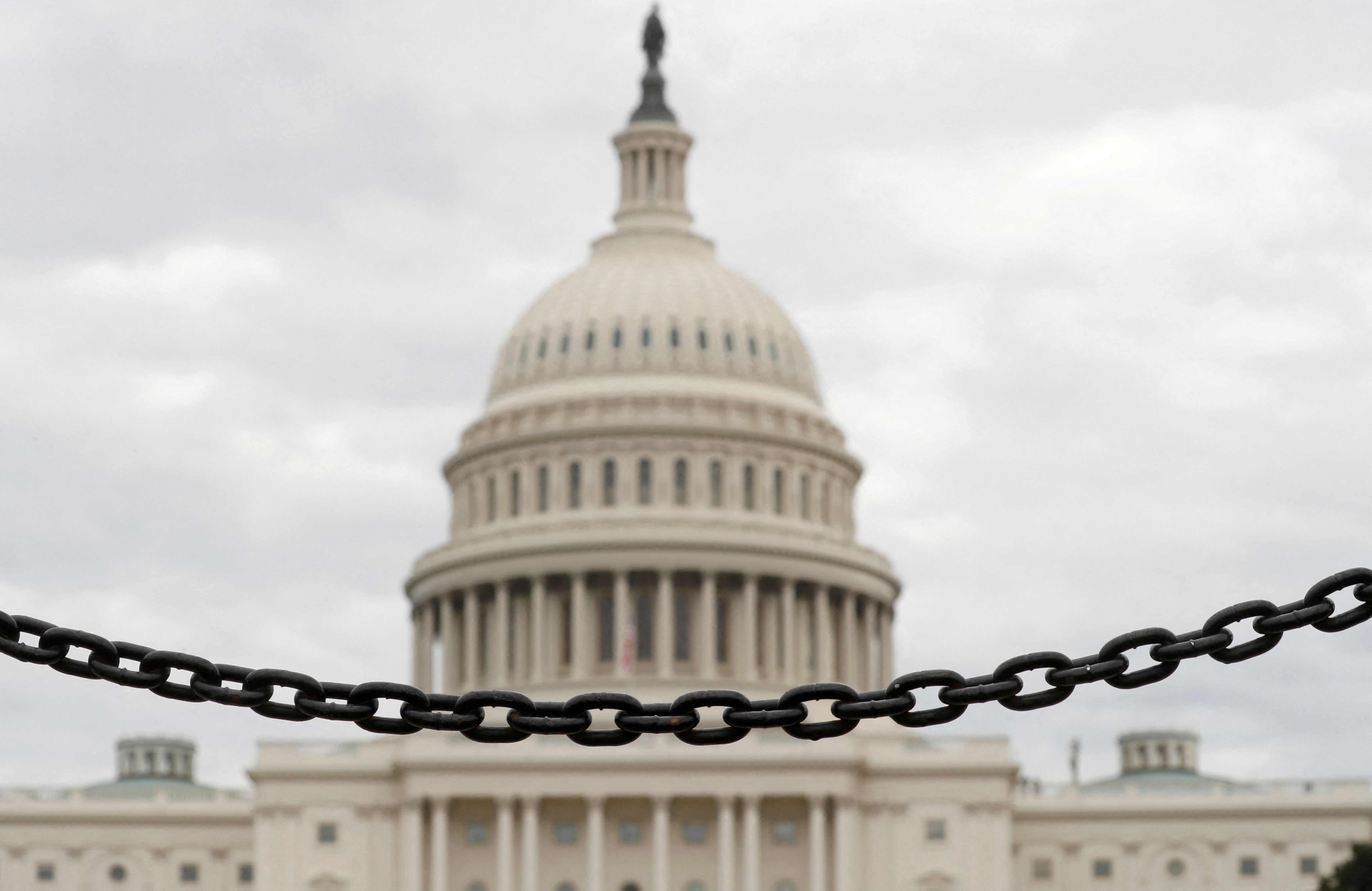 The dome of the U.S. Capitol is seen beyond a chain fence during the partial government shutdown in Washington, D.C., Jan. 8, 2019. 