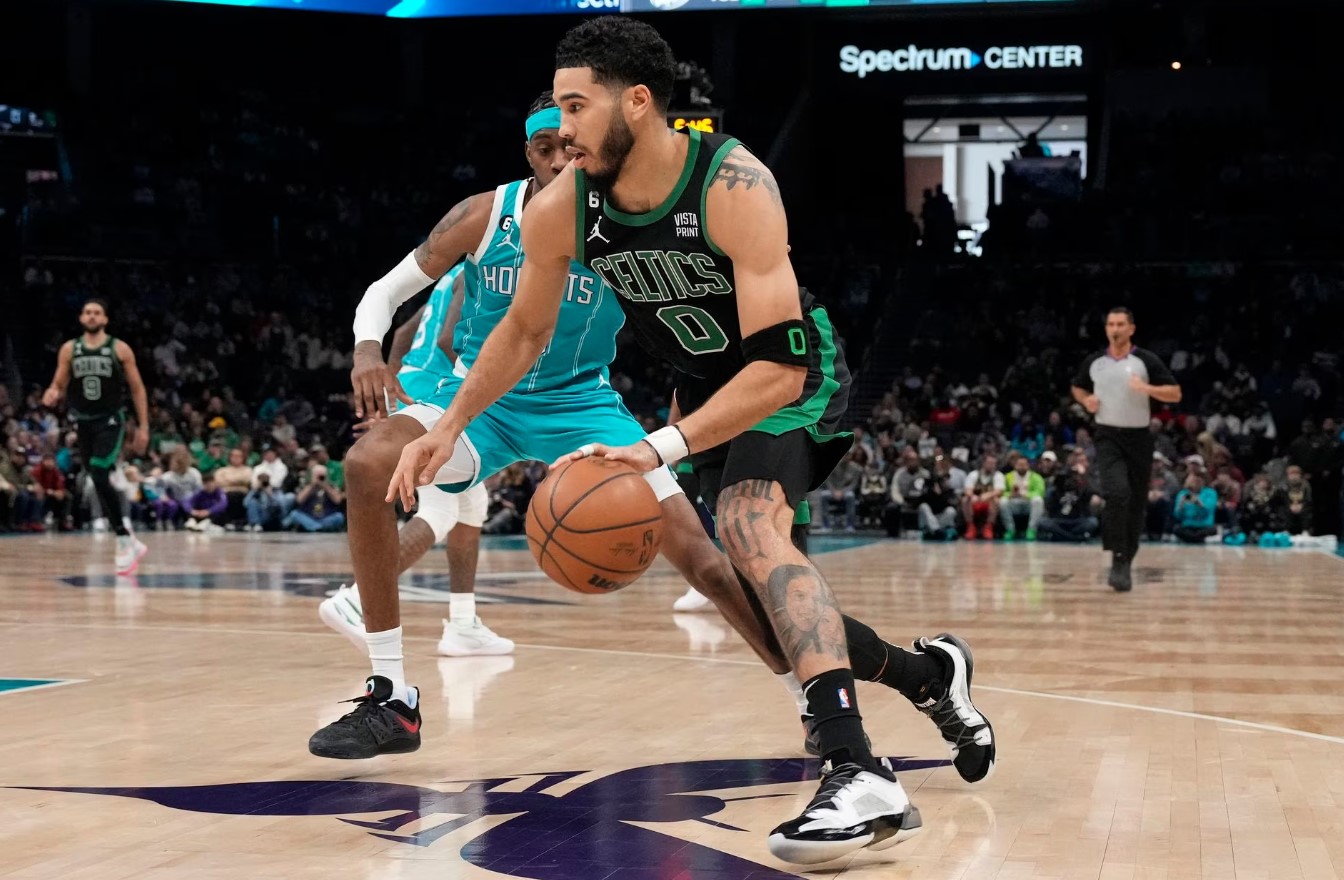 Boston Celtics forward Jayson Tatum (0) drives to the basket guarded by Charlotte Hornets forward Jalen McDaniels (6) during the first quarter at Spectrum Center in Charlotte, North Carolina, Jan. 16, 2023.