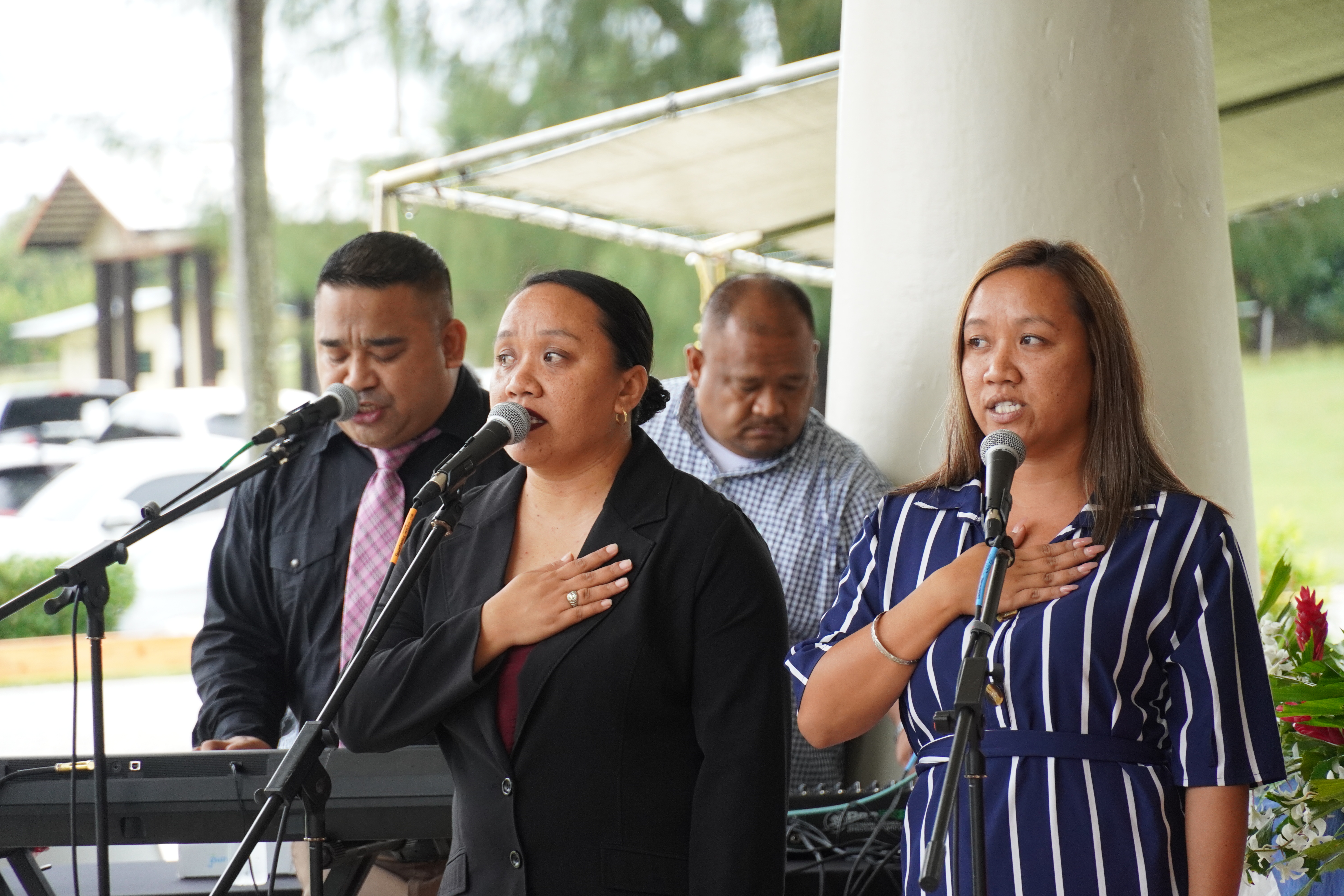 Javie and Janika Decena sing the CNMI anthem with Eric J. Reyes playing the piano.