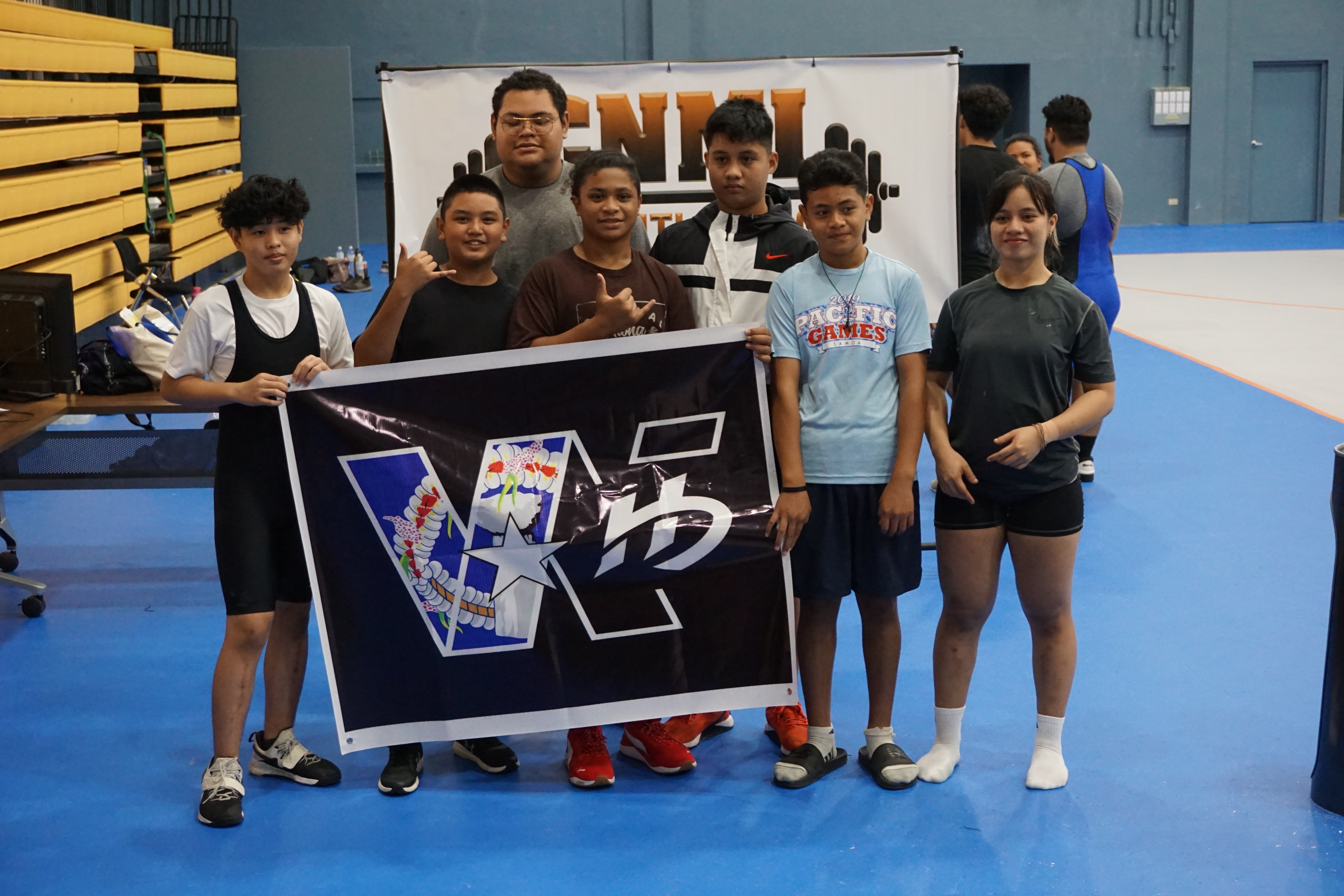 Young lifters pose for a photo after competing in the CNMI Weightlifting qualifier tournament on Saturday at the Ada gym.