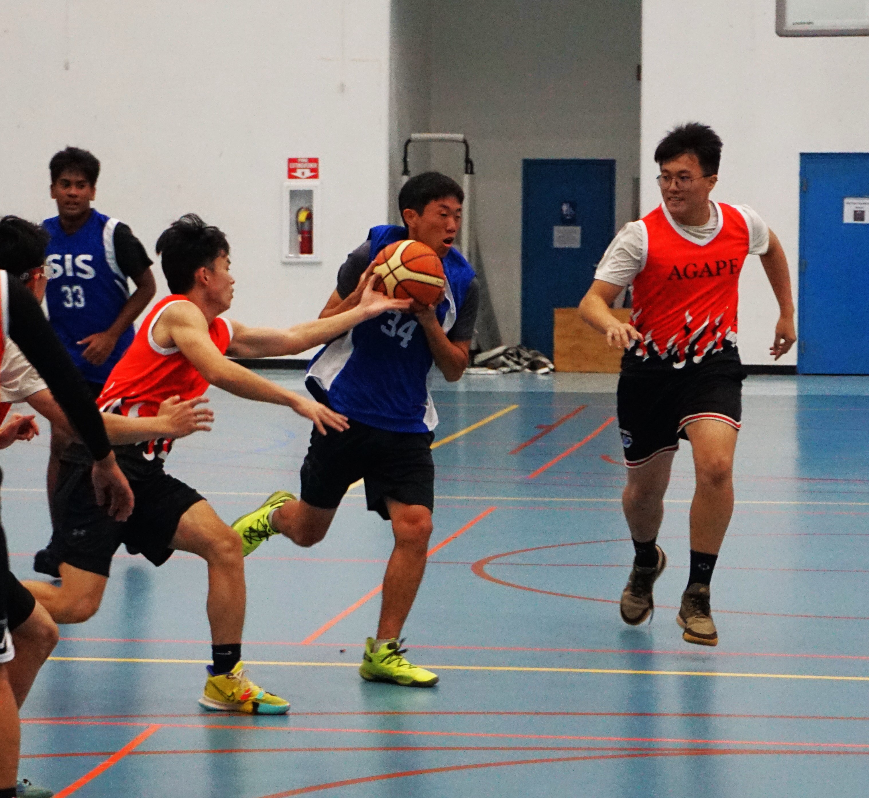 An ACS defender reaches in for the steal against SIS' Nam Yunwoo during a boys high school division game of the IT&E Interscholastic Basketball League on Wednesday at the MHS gym.