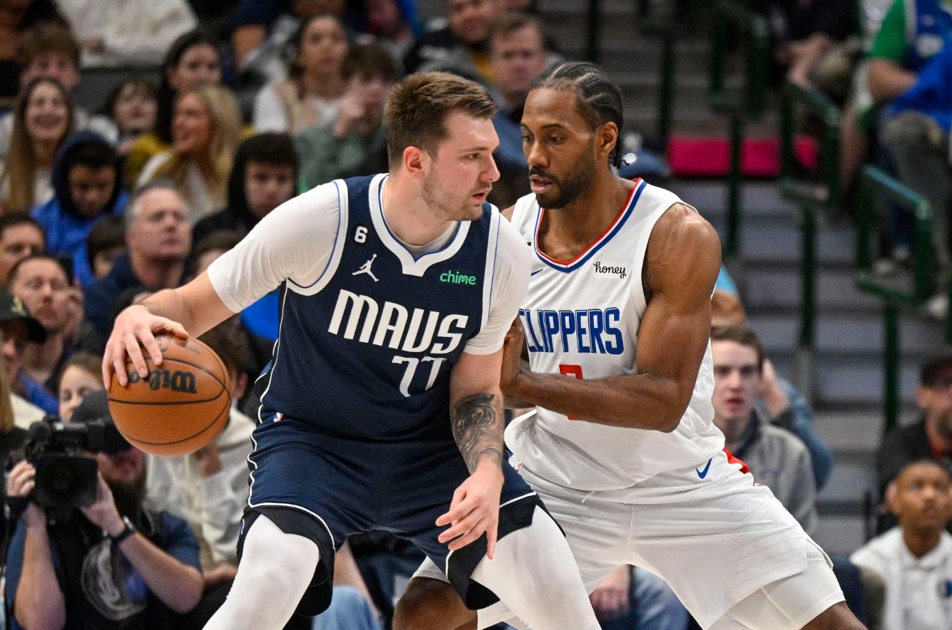 Dallas Mavericks guard Luka Doncic (77) looks to move the ball past LA Clippers forward Kawhi Leonard (2) during the second half at the American Airlines Center in Dallas, Texas, Jan. 22, 2023.