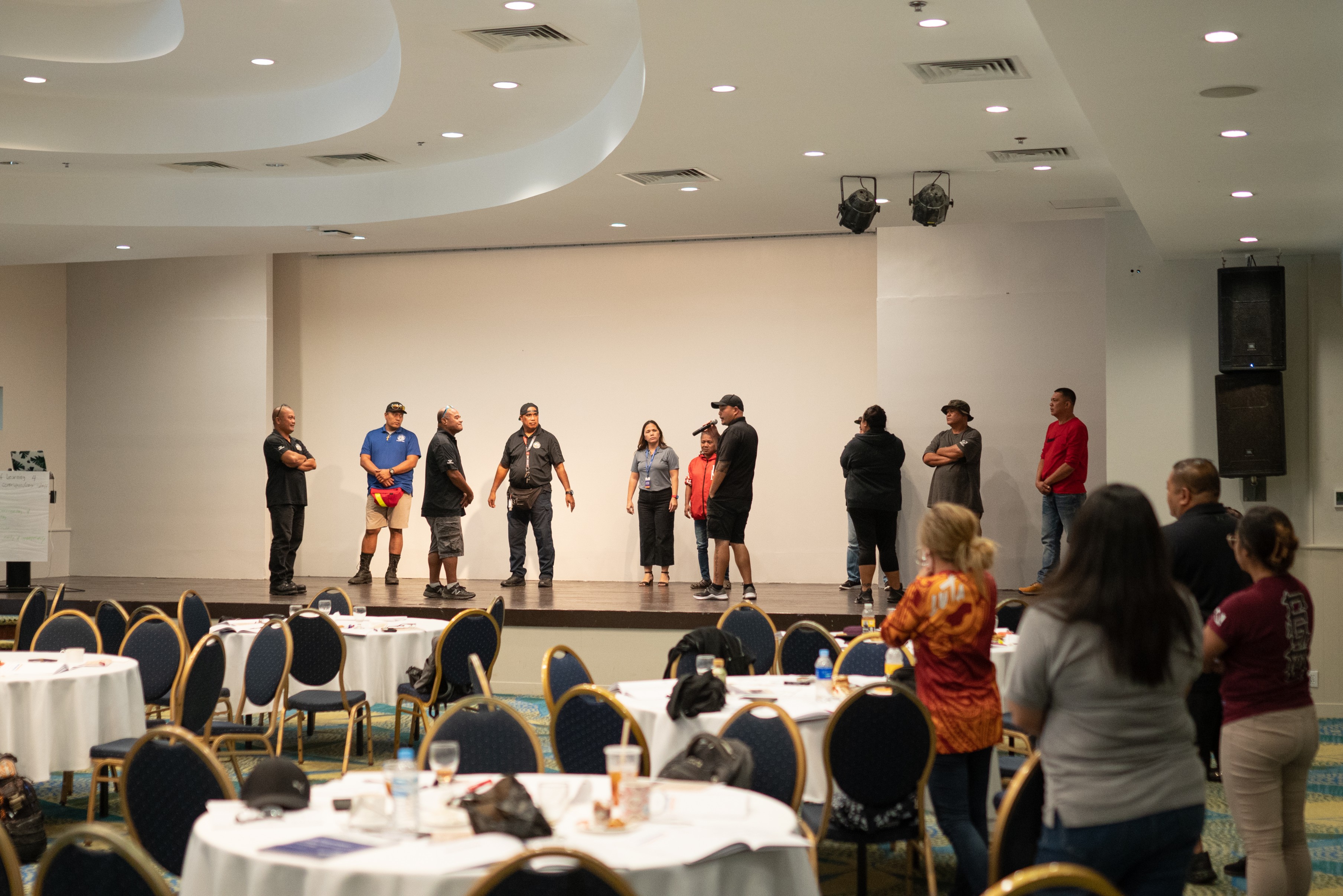 Public School System's Office of Pupil Transportation personnel  reenact on stage a real-life crisis scenario as PSS Family and Community Engagement Director Liela Yumul, center, observes them.