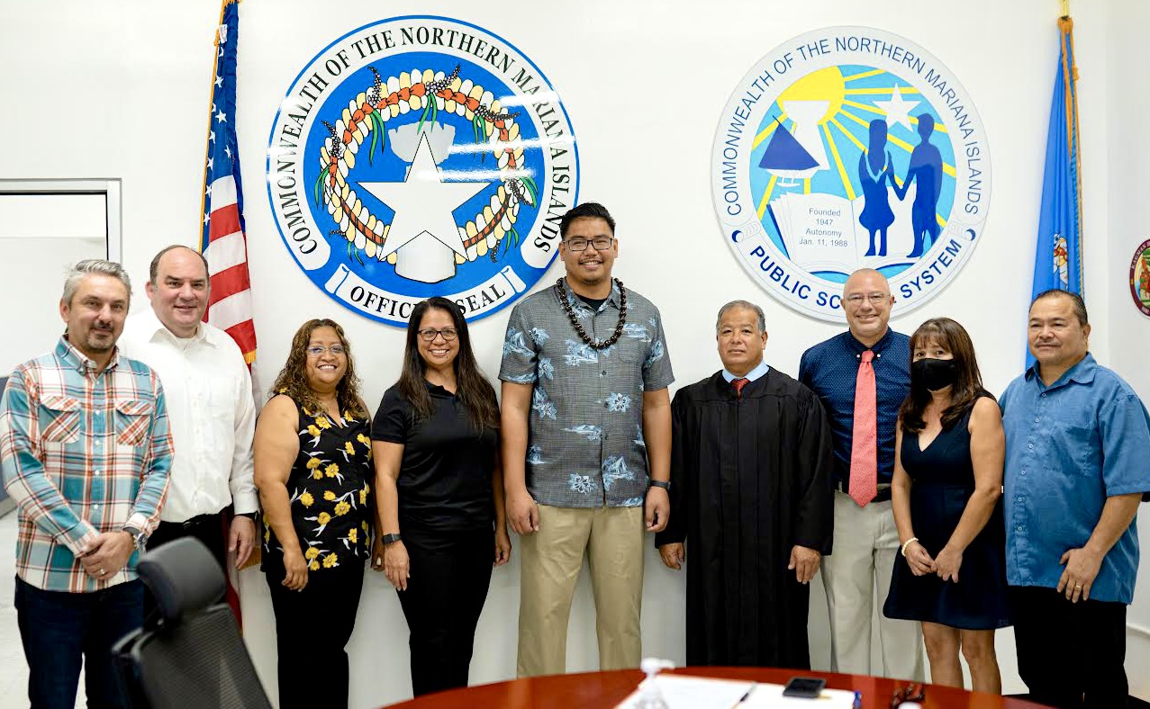 Board of Education Vice Chairman L. Antonio Borja, center, poses for a photo with legal counsels Michael Ernest and Tiberius Mocanu, BOE staffers Valerie Malwelbug and Delia Maratita, BOE Chairman Gregory Pat Borja, BOE Secretary/Treasurer Maisie B. Tenorio, Commissioner of Education Dr. Alfred B. Ada and Supreme Court Justice Perry Inos.