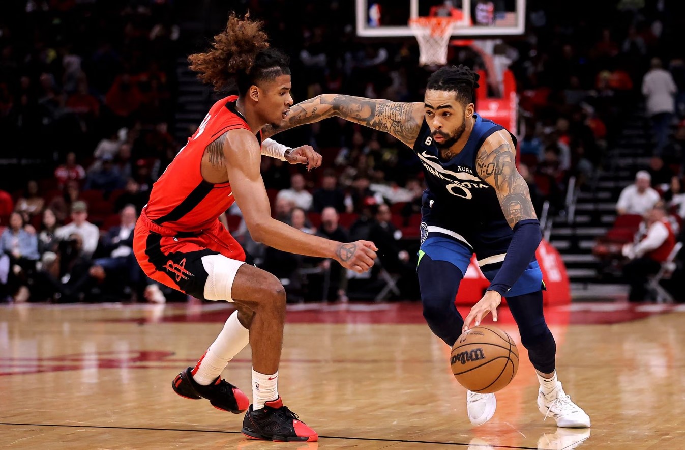 Minnesota Timberwolves guard D'Angelo Russell (0) drives to the basket while Houston Rockets guard Jalen Green (4) defends during the fourth quarter at Toyota Center in Houston, Texas, Jan. 23, 2023.
