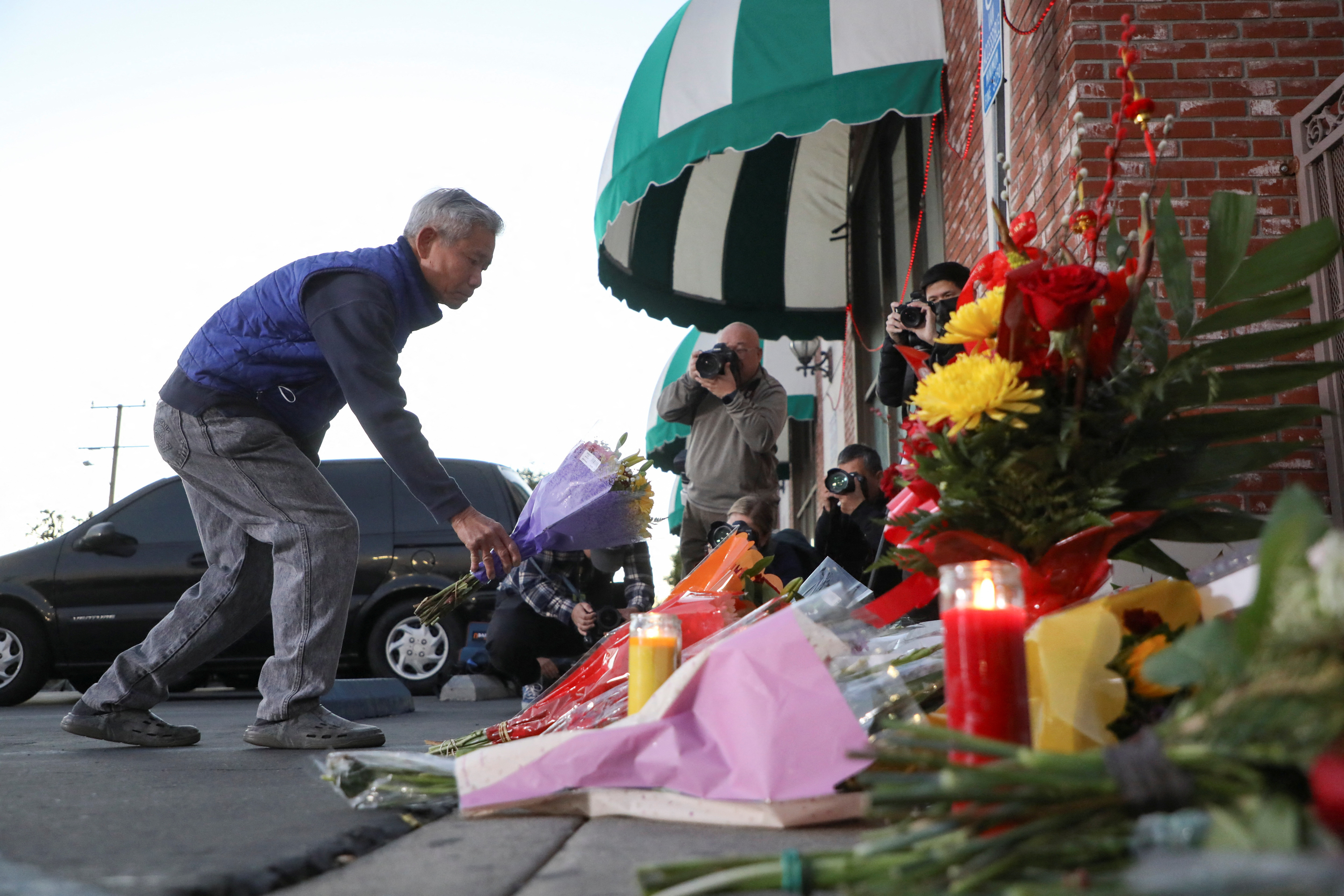 People mourn outside the entrance of the Star Ballroom Dance Studio after a mass shooting during Chinese Lunar New Year celebrations in Monterey Park, California, Jan. 23, 2023.