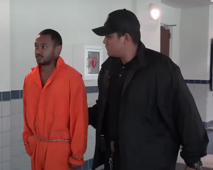 Jason Yamada is escorted by a Corrections officer at the Guma’ Hustisia.