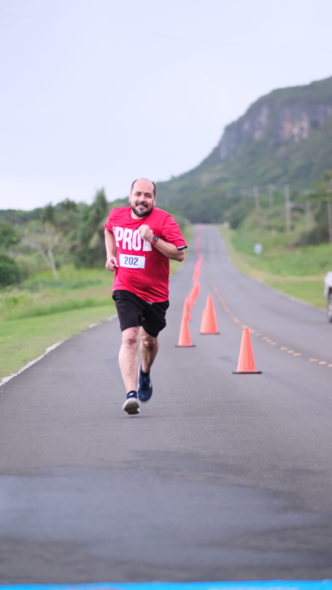 Galvin Deleon Guerrero smiles as he nears the finish line of Run From '22 on Saturday at the former Mariana Resort.