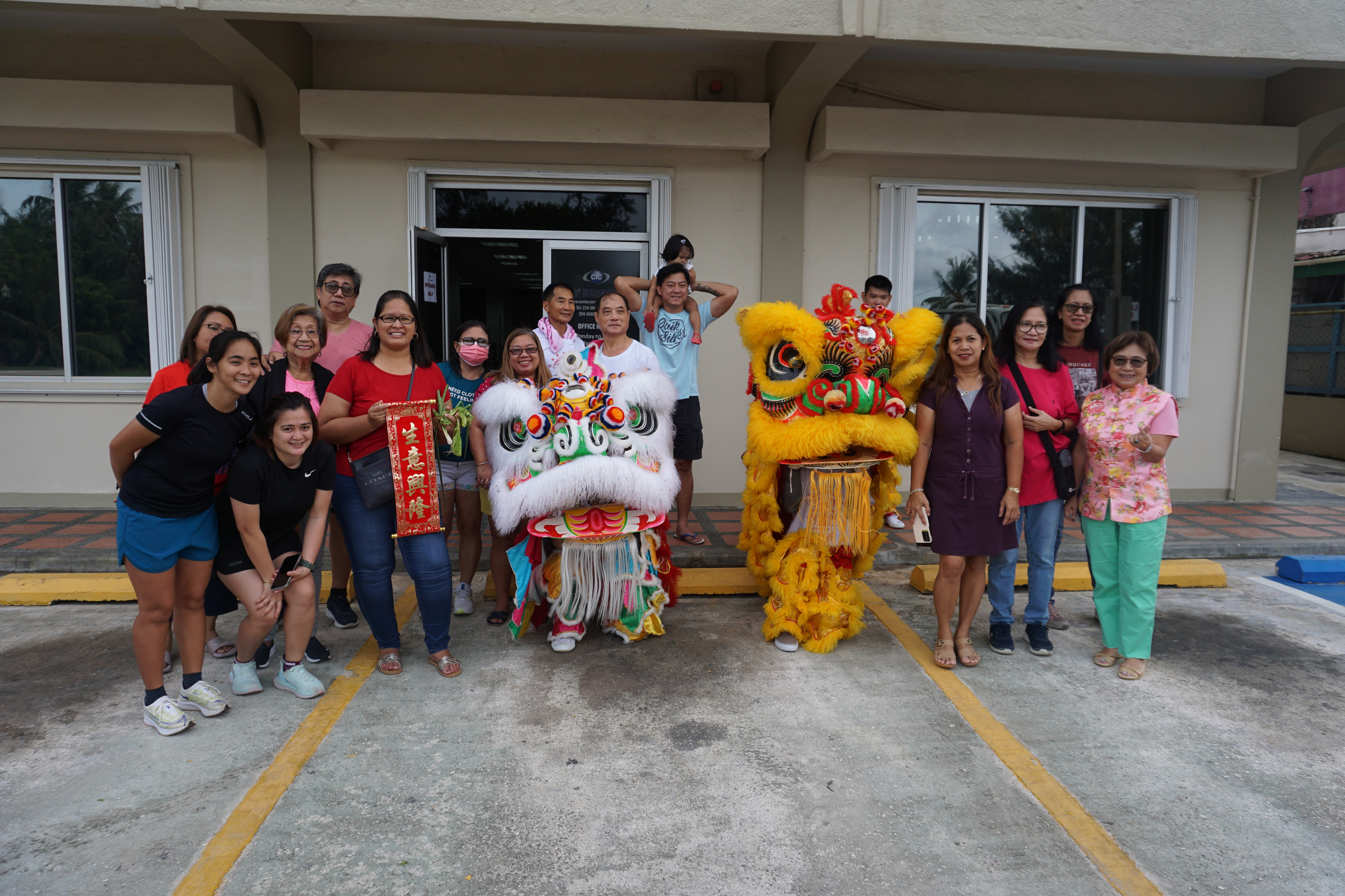 Community members and visitors pose for a photo with some of the Lion dancers at the JP Center in Garapan on Sunday morning.