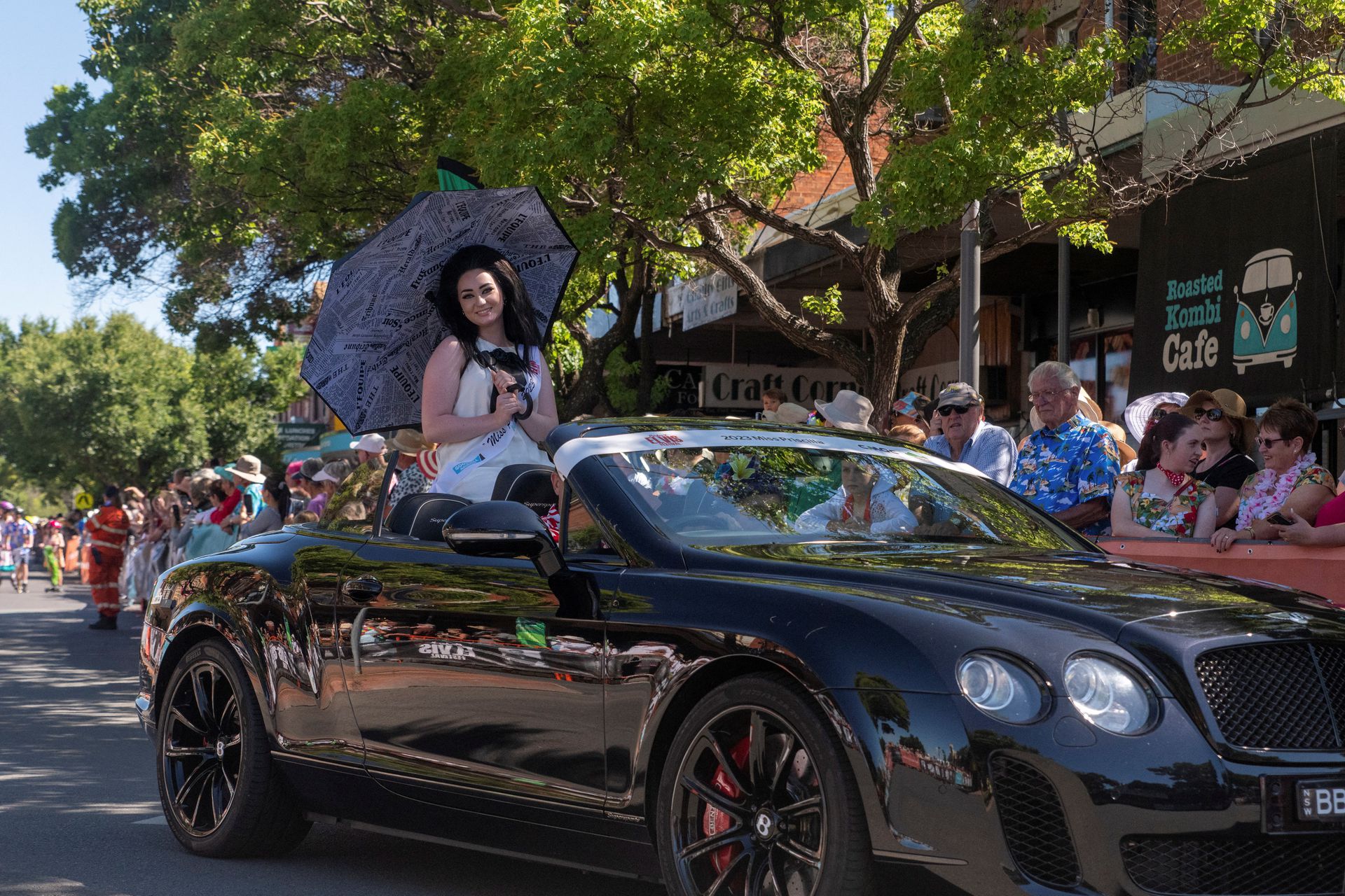 Winner of Parkes Elvis Festival Miss Priscilla 2023, Nickyra Burley, sits on top a car during the festival parade in Parkes, Australia, Jan. 7, 2023.