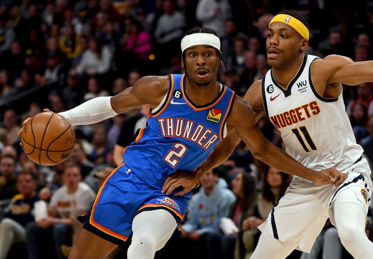 Oklahoma City Thunder guard Shai Gilgeous-Alexander (2) drives on Denver Nuggets forward Bruce Brown (11) during the first quarter at Ball Arena in Denver, Colorado, Jan. 22, 2023.