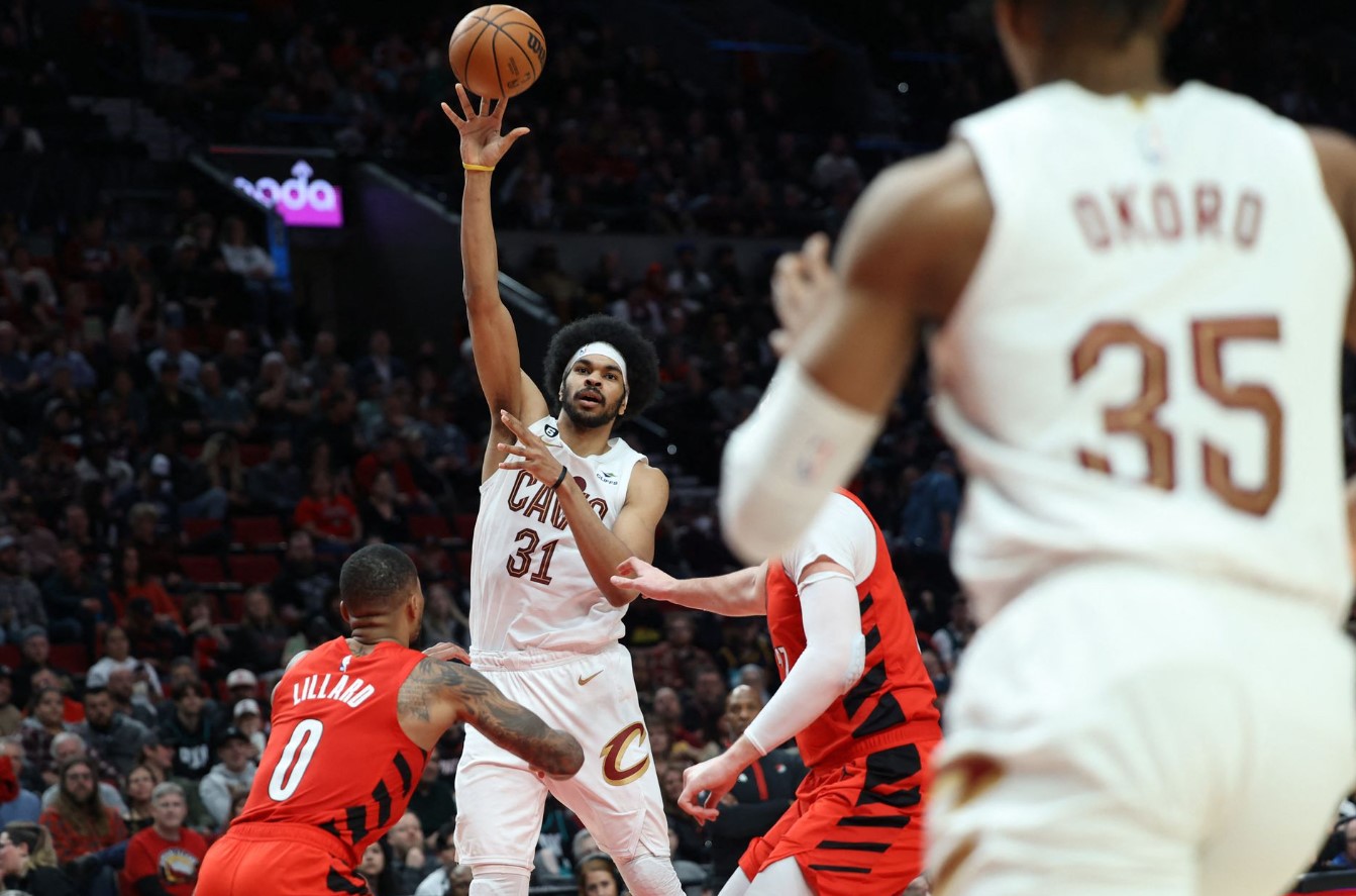Cleveland Cavaliers center Jarrett Allen (31) passes the ball over Portland Trail Blazers guard Damian Lillard (0) in the second half at Moda Center in Portland, Oregon, Jan. 12, 2023.