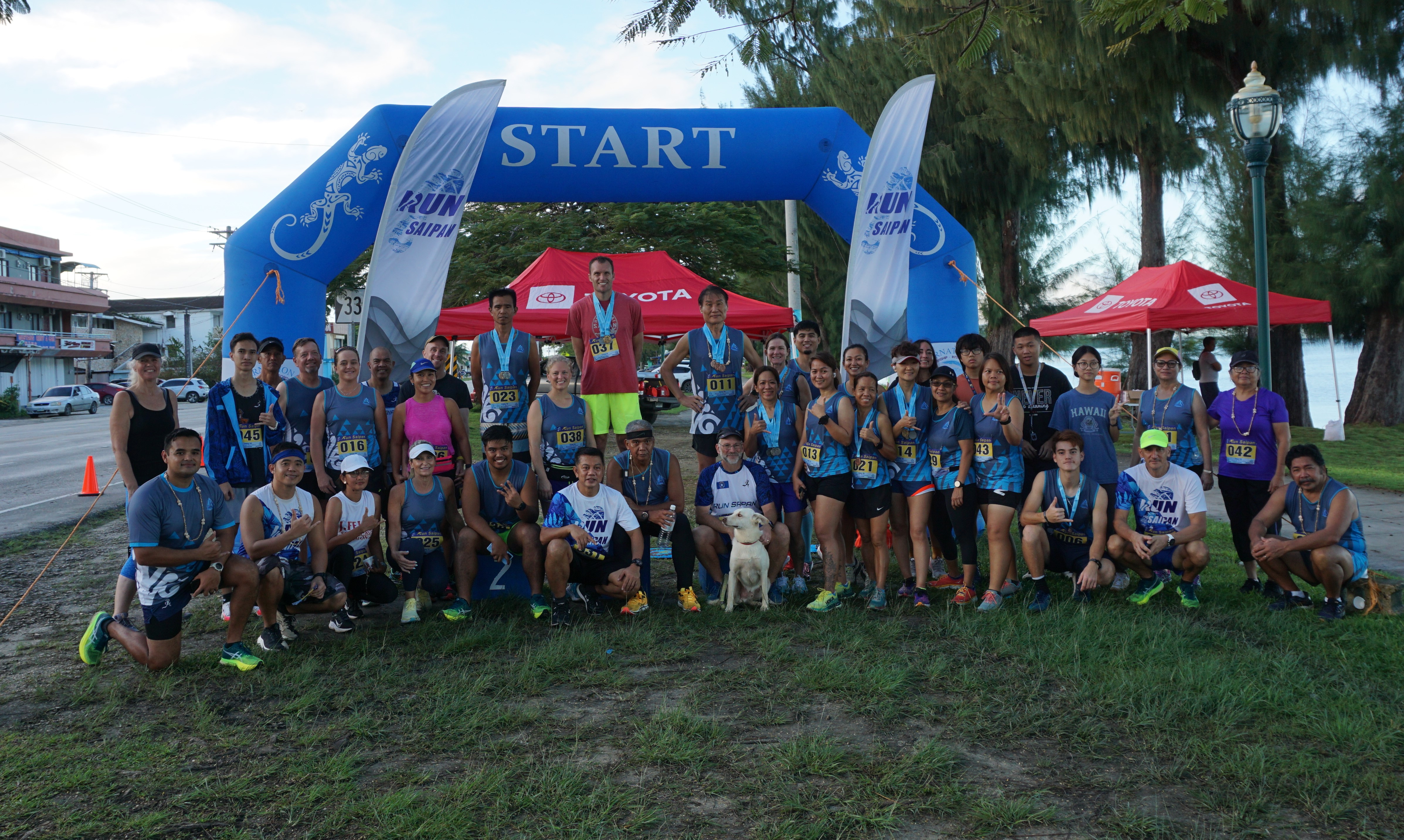Run Saipan Trinity participants pose for a photo on Monday, Day 3 of the event, on Beach Road in Oleai.