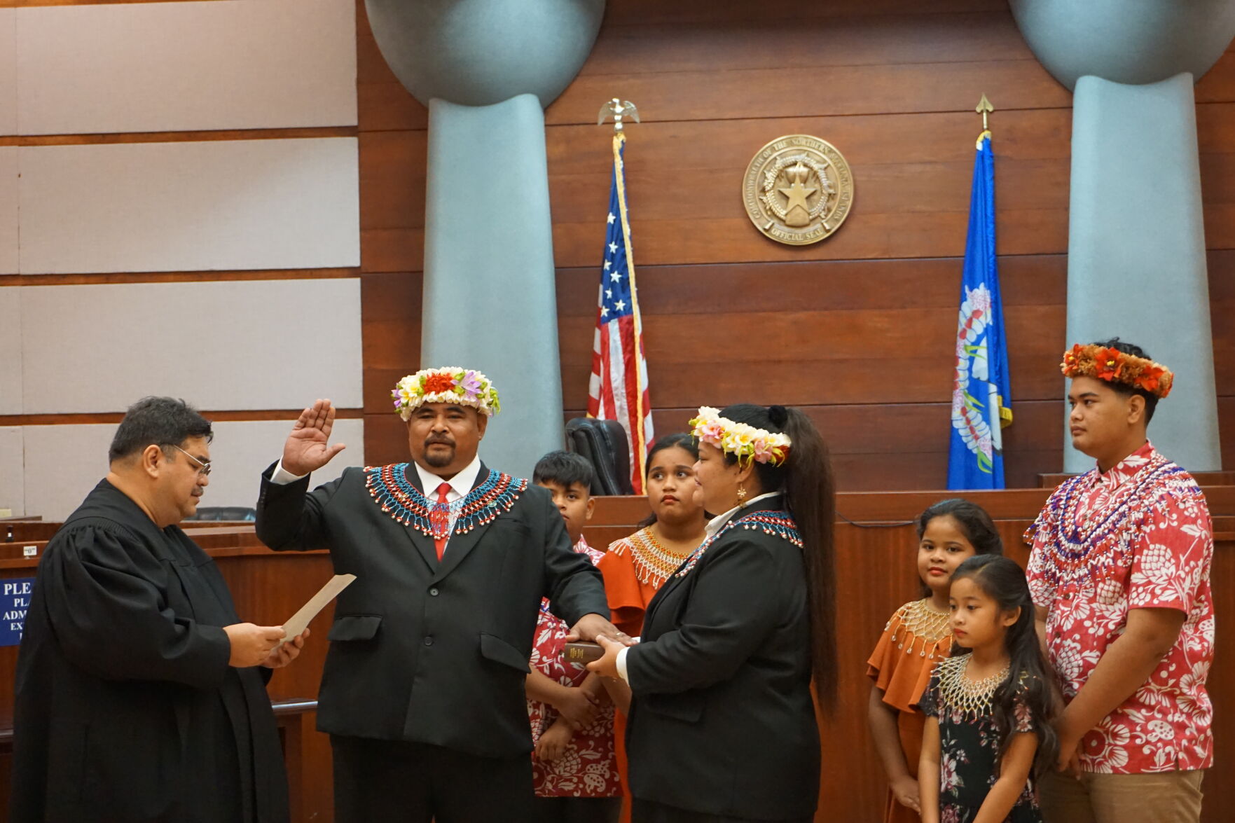 Associate Judge Joseph James N. Camacho administers the oath of office to Northern Islands Mayor Valentino Nicky Taisacan as his family members look on at the Guma Hustisia on Monday morning.