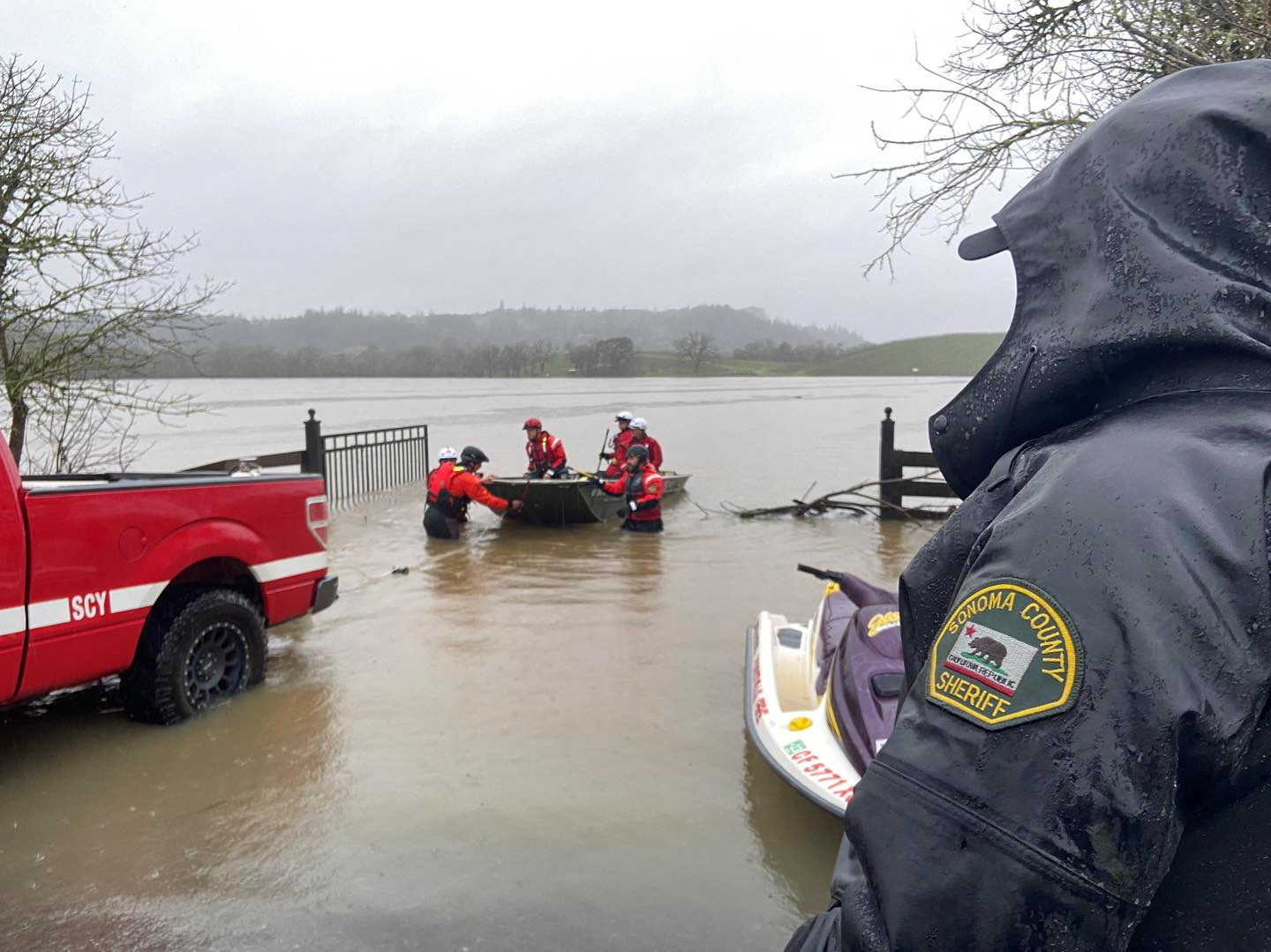 Emergency crew members in a boat work near the spot where a car was found submerged in floodwater with a dead 43-year-old woman inside, officials reported, in Sonoma County, California, Jan. 11, 2023 in this picture obtained from social media.
