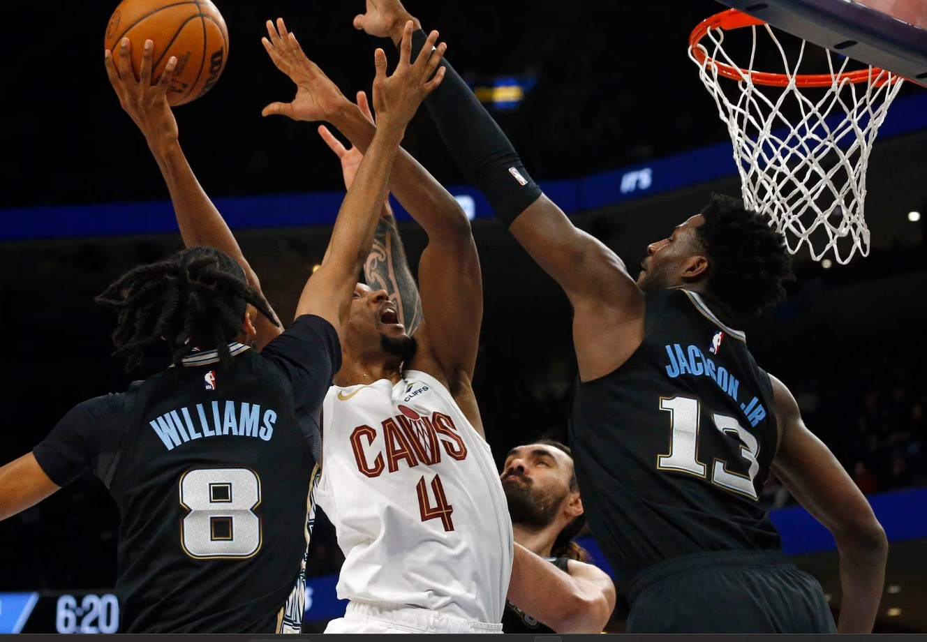 Cleveland Cavaliers forward Evan Mobley (4) shoots as Memphis Grizzlies forward Ziaire Williams (8), center Steven Adams (4) and forward Jaren Jackson Jr. (13) defend during the first half at FedExForum Memphis, Tennessee on  Jan. 18, 2023.