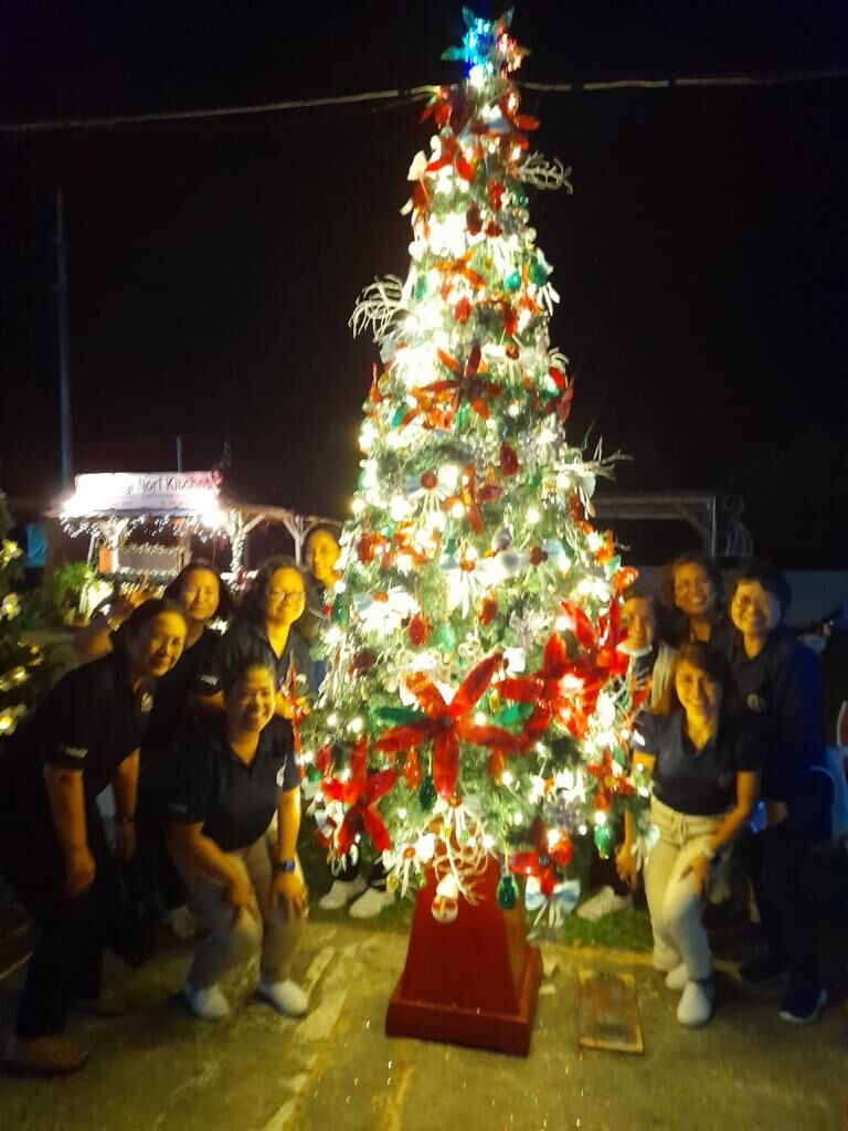 Mount Carmel School faculty stand by the school’s recycled Christmas Tree as part of the Marianas Visitors Authority’s Recycled Christmas Tree Competition at the Christmas Village in Garapan.