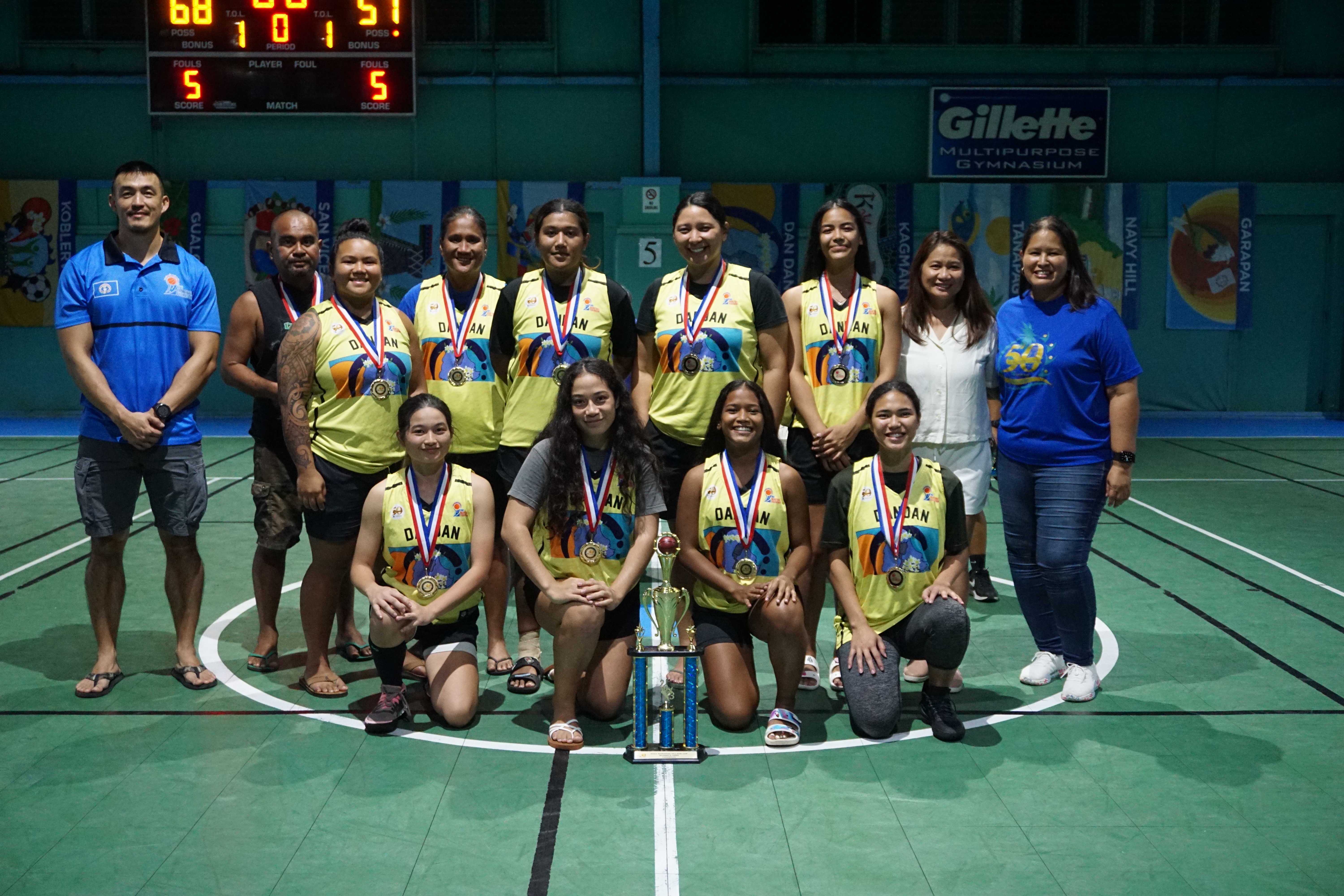 The Dandan players pose with their medals and women's division championship trophy during the awards ceremony of the 2022 Marianas Village Pride Basketball League at the TSL Sports Complex on Sunday.