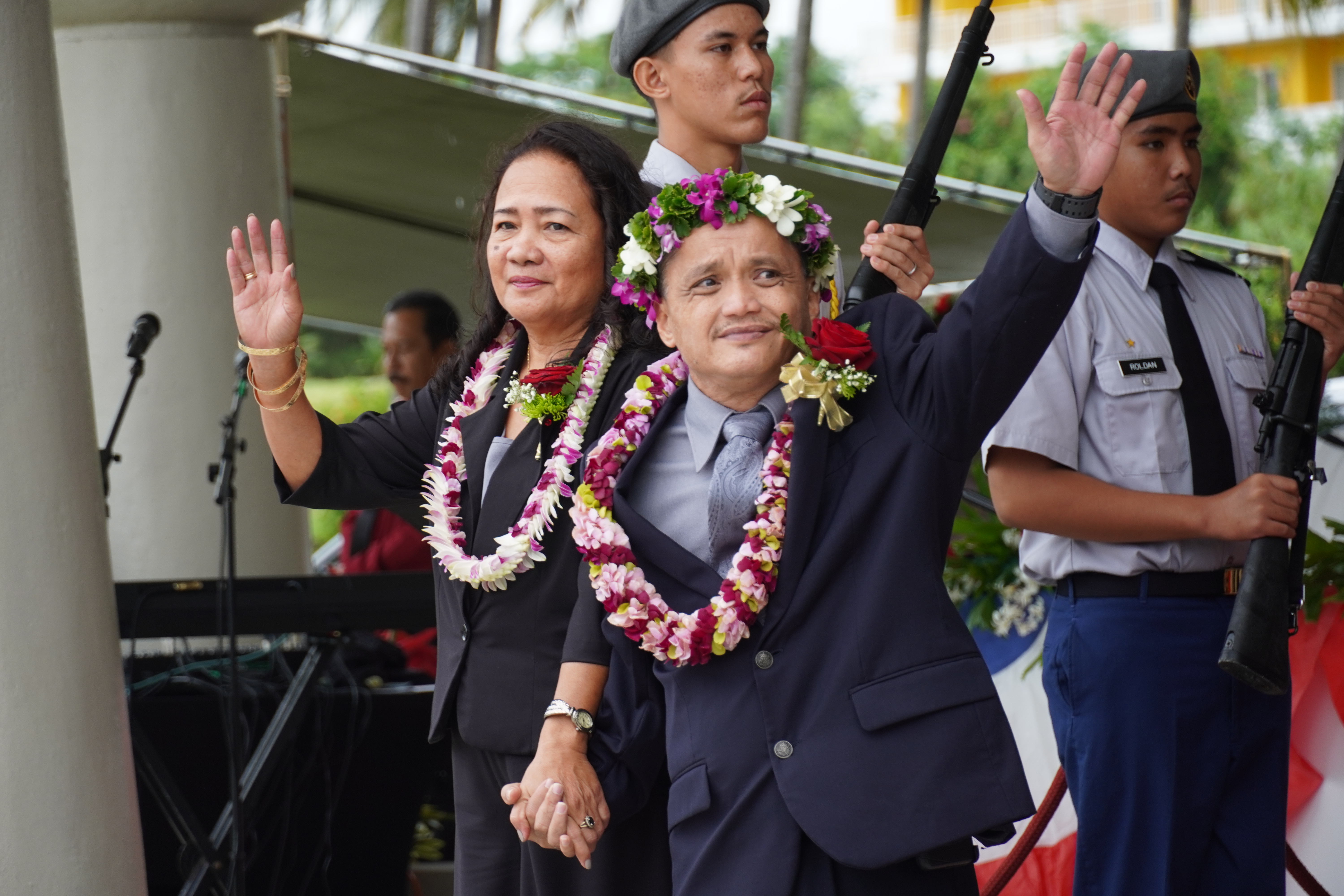 Newly elected Tinian Municipal Council secretary Estevan Pangelinan Cabrera, right, and his wife, Maria Editha, wave at the crowd during the inaugural ceremony Friday on Tinian.