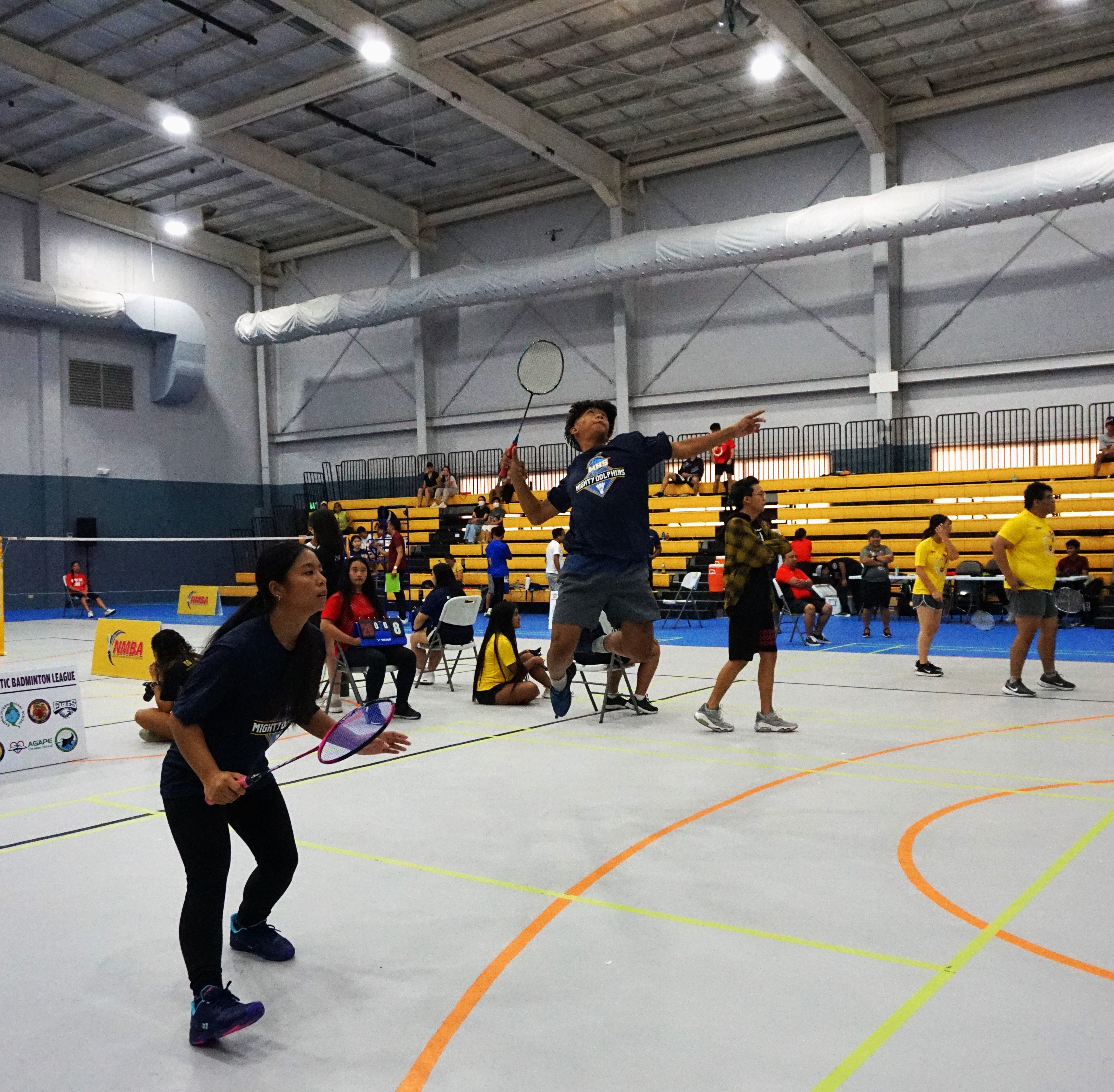 MHS 2's Marlon Bautista leaps for a powerful smash during a mixed doubles event of the NMBA-PSS Interscholastic Badminton League on Saturday at the Ada gym. Also in photo is his team mate, Angieleysha Punzalan.