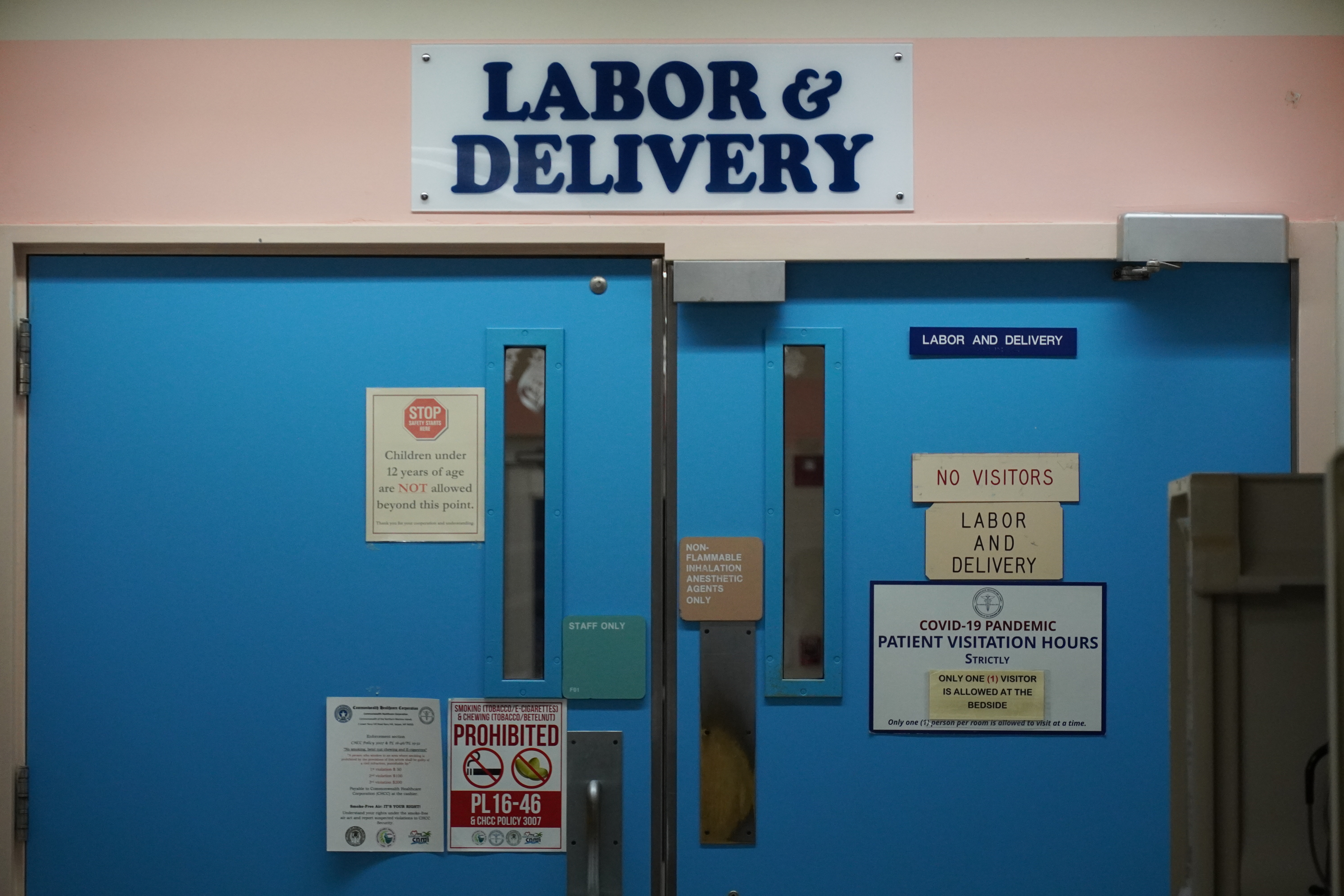 Secured double doors lead to the Labor and Delivery section of the Commonwealth Healthcare Corporation's Obstetrics and Gynecology Ward.