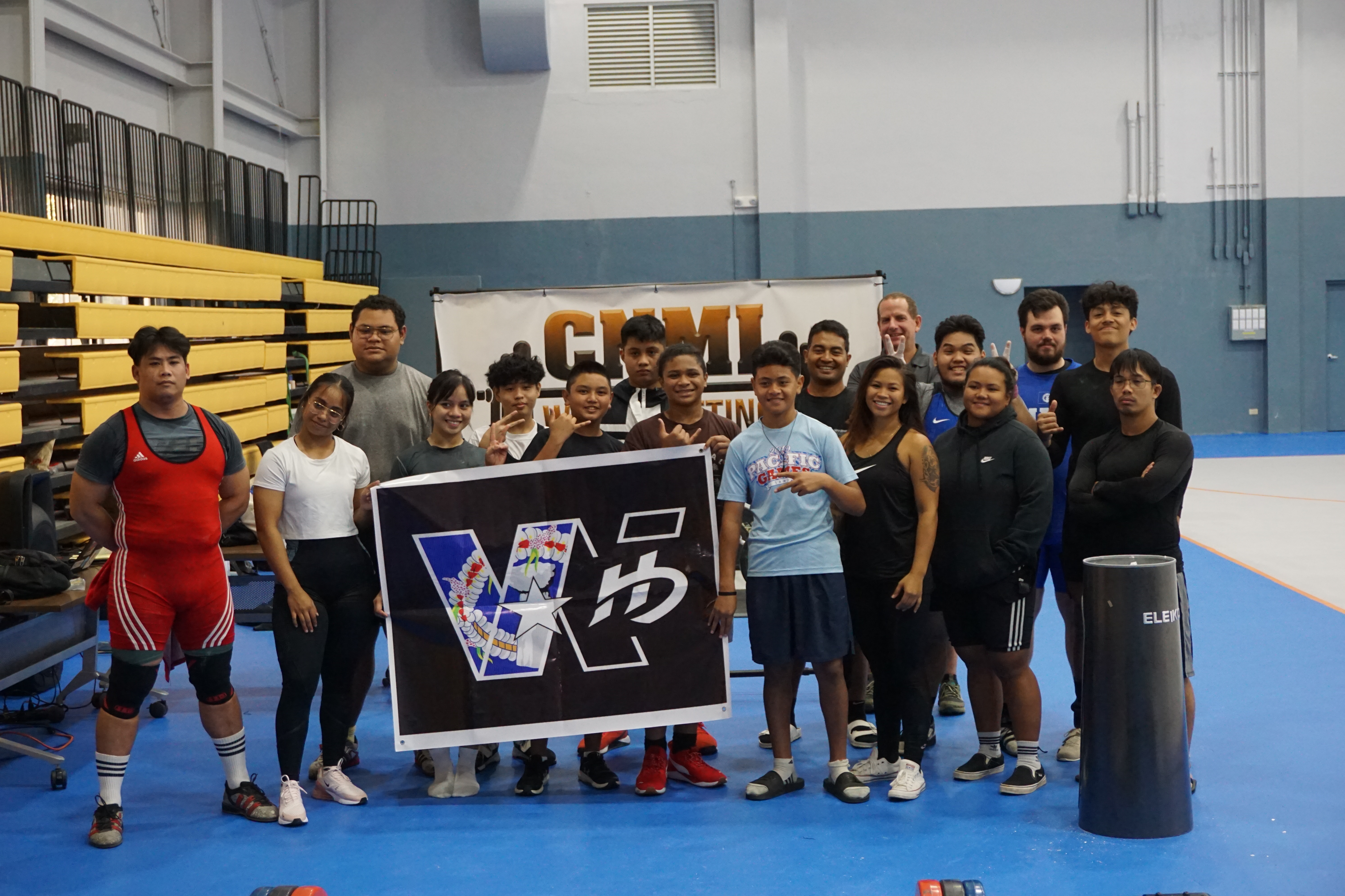 The participating weightlifters pose for a photo after the conclusion of the CNMI Weightlifting qualifier at the Ada gym on Saturday.