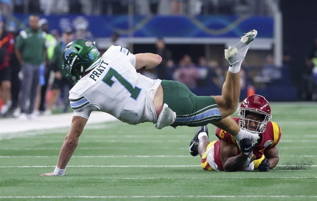 Tulane Green Wave quarterback Michael Pratt (7) dives over USC Trojans defensive back Mekhi Blackmon (6) during the second half in the 2023 Cotton Bowl at AT&T Stadium in Arlington, Texas, Jan. 2, 2023.