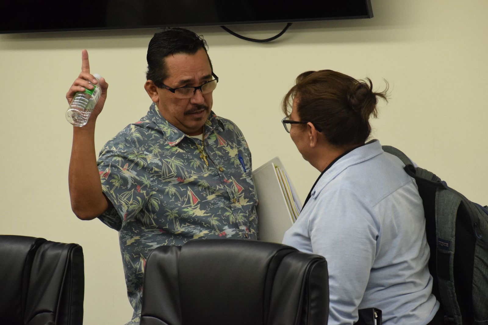 Rep. Patrick San Nicolas, left, gestures as he talks with then-Rep. Celina Babauta following a House session in December 2022. 