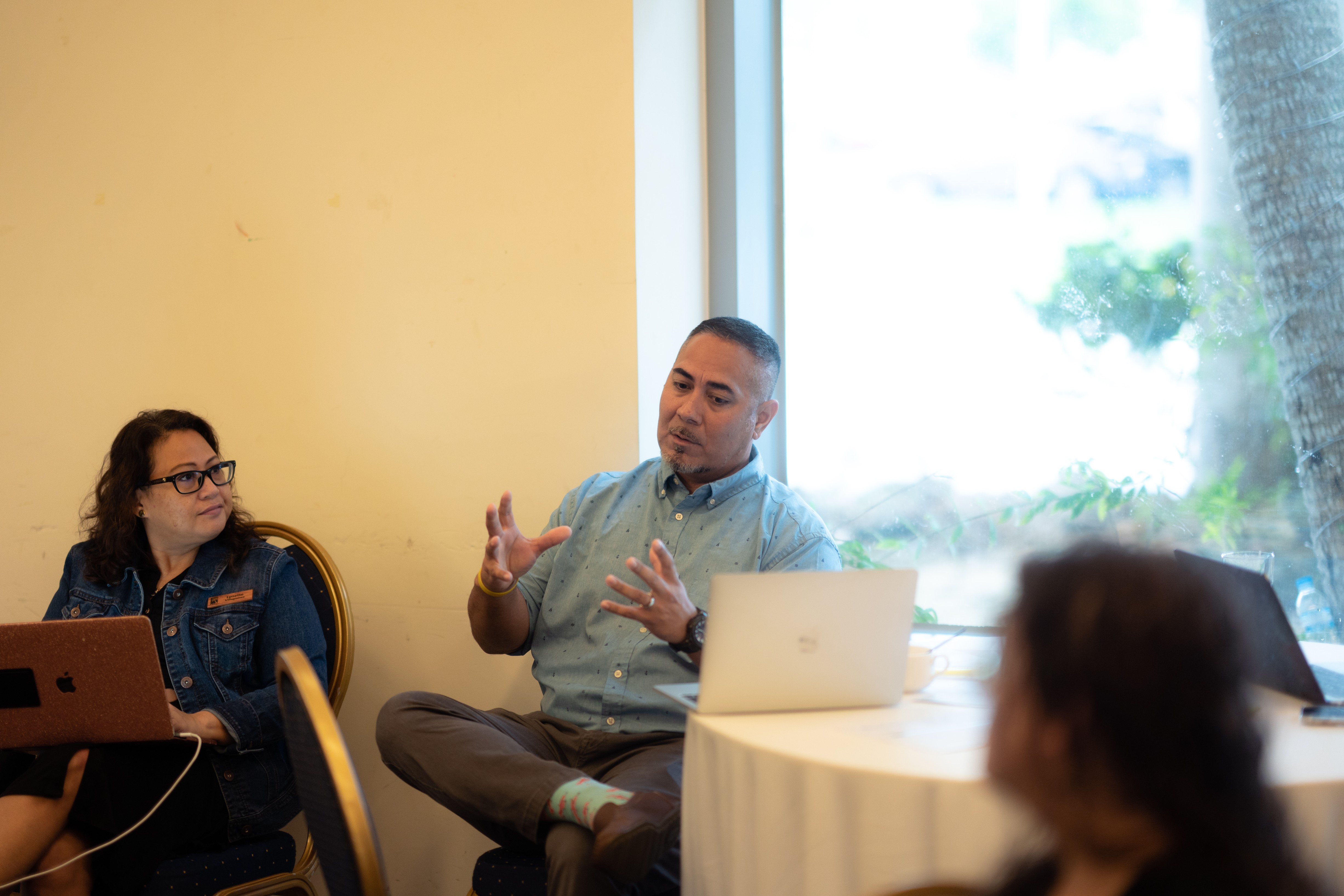 Science Curriculum Program Director Asapmar Ogumoro stresses  a point as Region 18 Comprehensive Center Senior Research Specialist for PREL Lynette Villagomez listens.
