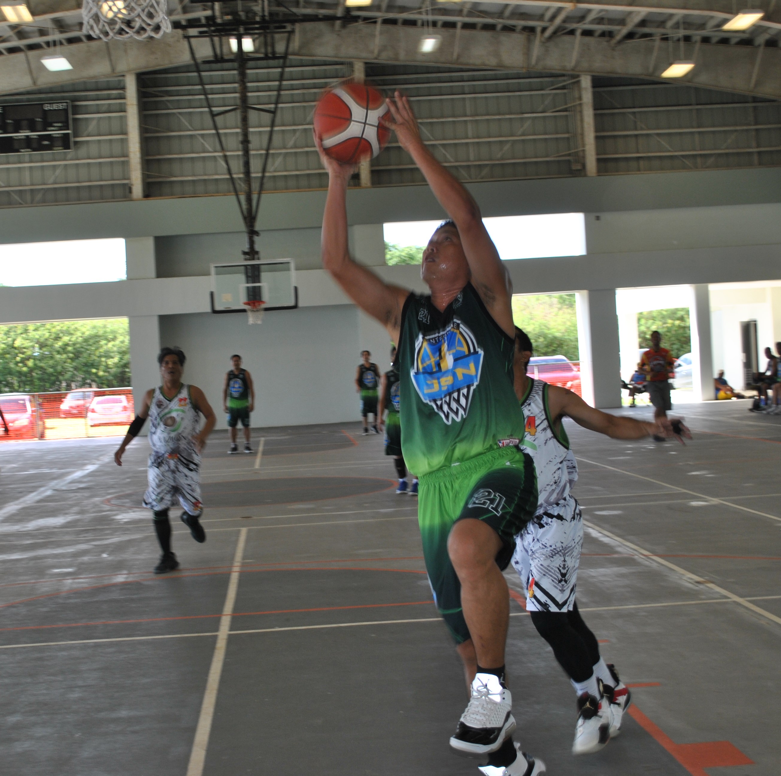 Jorge De Guzman, who plays for Napa Auto Parts in the Open Division, extends for the finish during a masters division game of the 2022 Legends Sports Association Invitational Basketball League at the Koblerville gym.