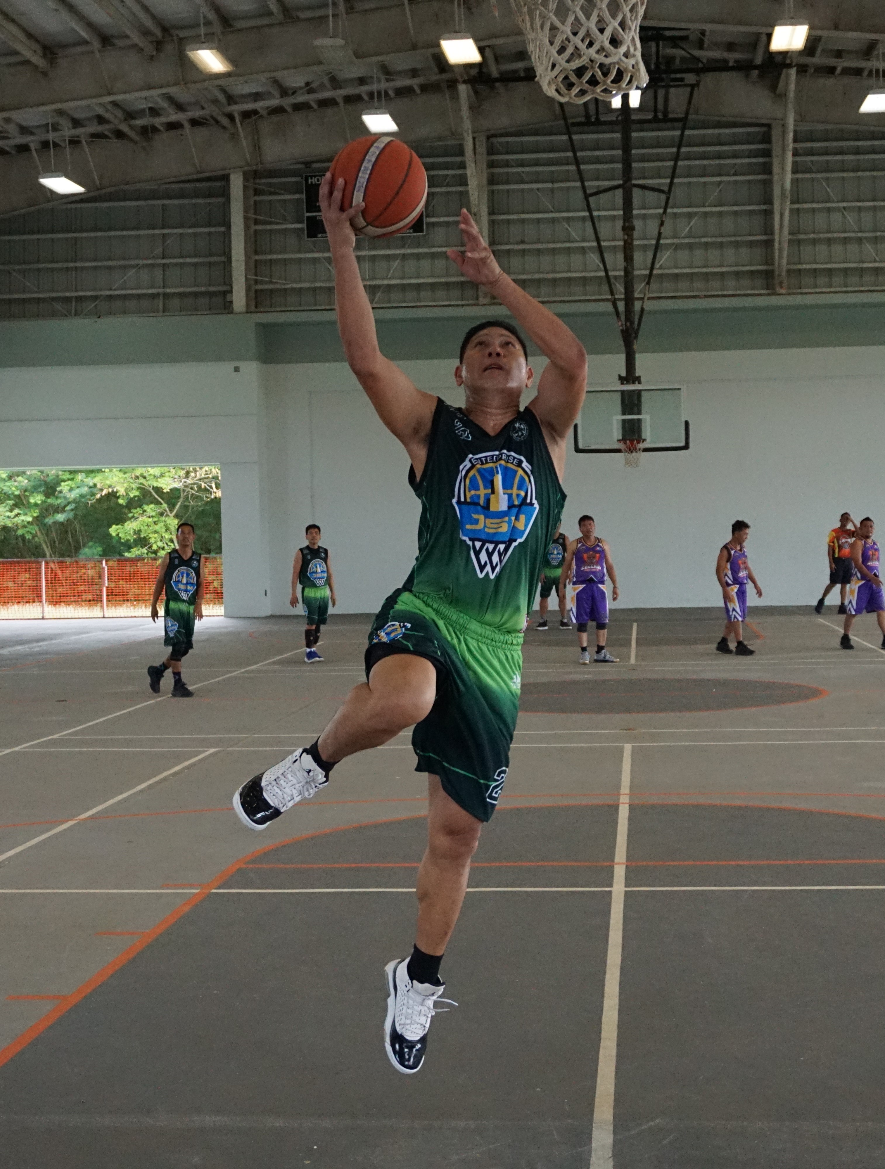 JSN Construction's Jorge De Guzman takes the uncontested layup during a semifinal game Sunday in the masters division of the Legends Sports Association Invitational Basketball League at Koblerville gym.