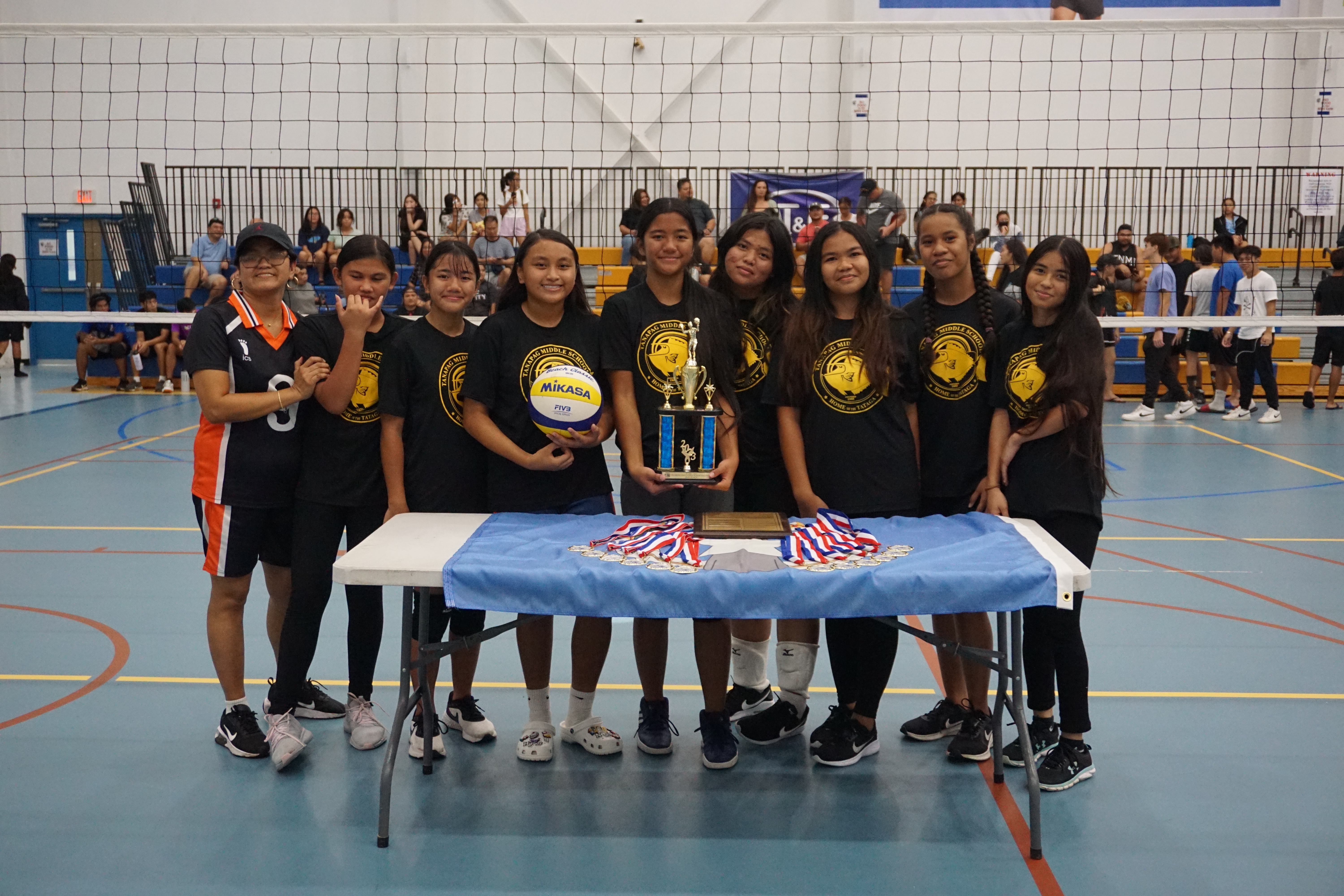 Tanapag Middle School players pose for  a photo with their second-place trophy.