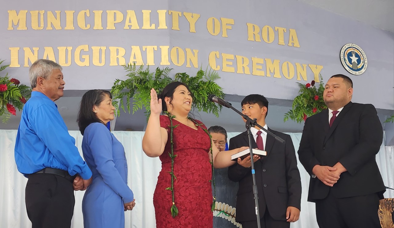 Rota Mayor Aubry M. Hocog, center, takes her oath of office, surrounded by her parents, son, and partner. Also pictured is Chief Justice Alexandro C. Castro, standing behind Hocog, administering the oath.