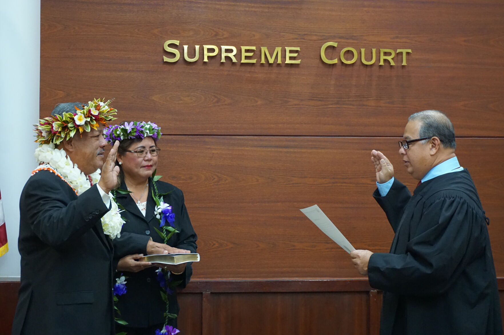 Tinian and Aguiguan Mayor Edwin Palacios Aldan is sworn in by Justice Perry B. Inos at the Guma Hustisia on Monday morning while the mayor’s wife, Rosita, holds the Bible.