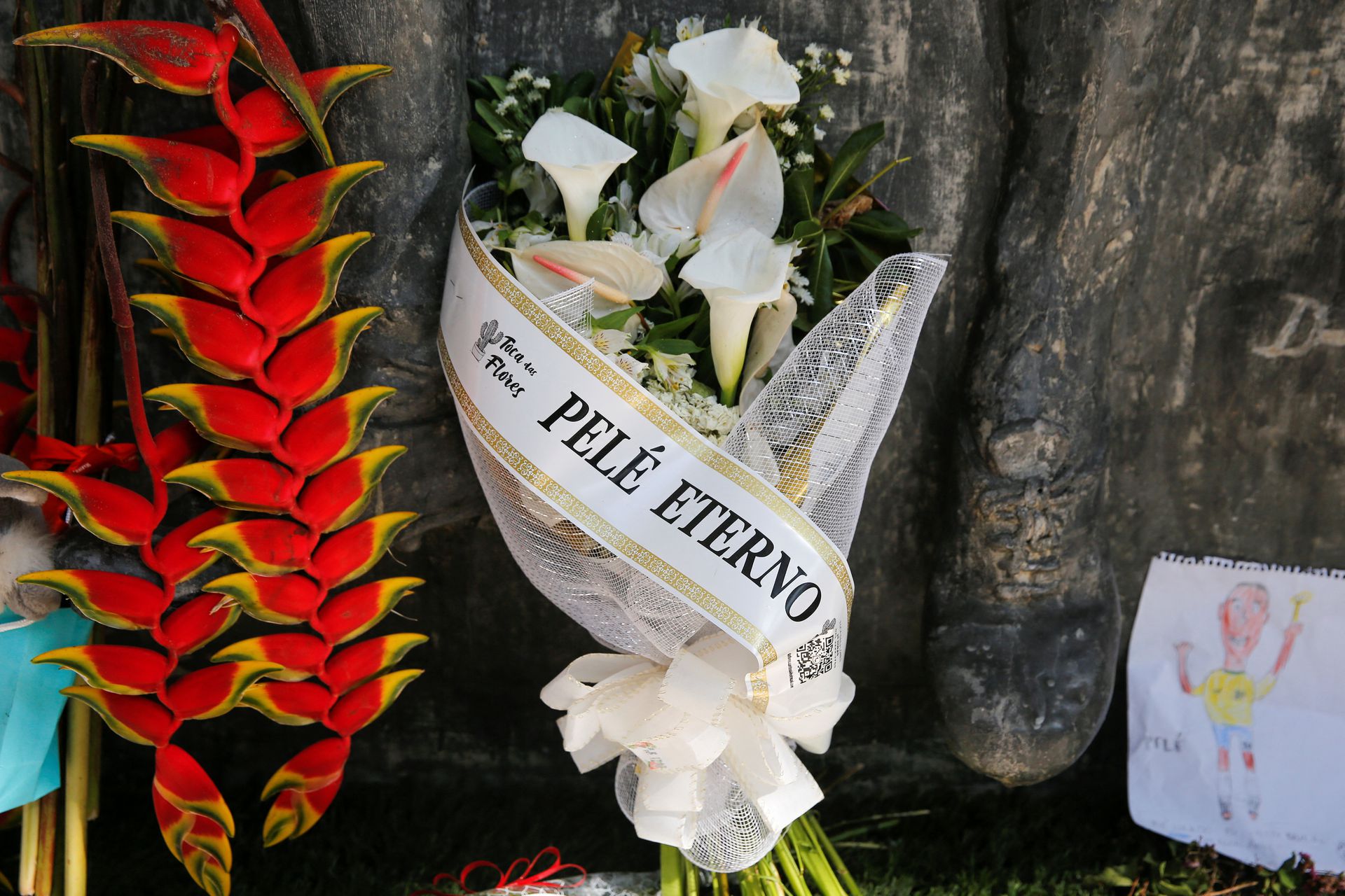 A bouquet of flowers reading "Eternal Pele” is seen near the Vila Belmiro stadium on the eve of Pele's funeral in Santos, Brazil, Jan. 1, 2023.