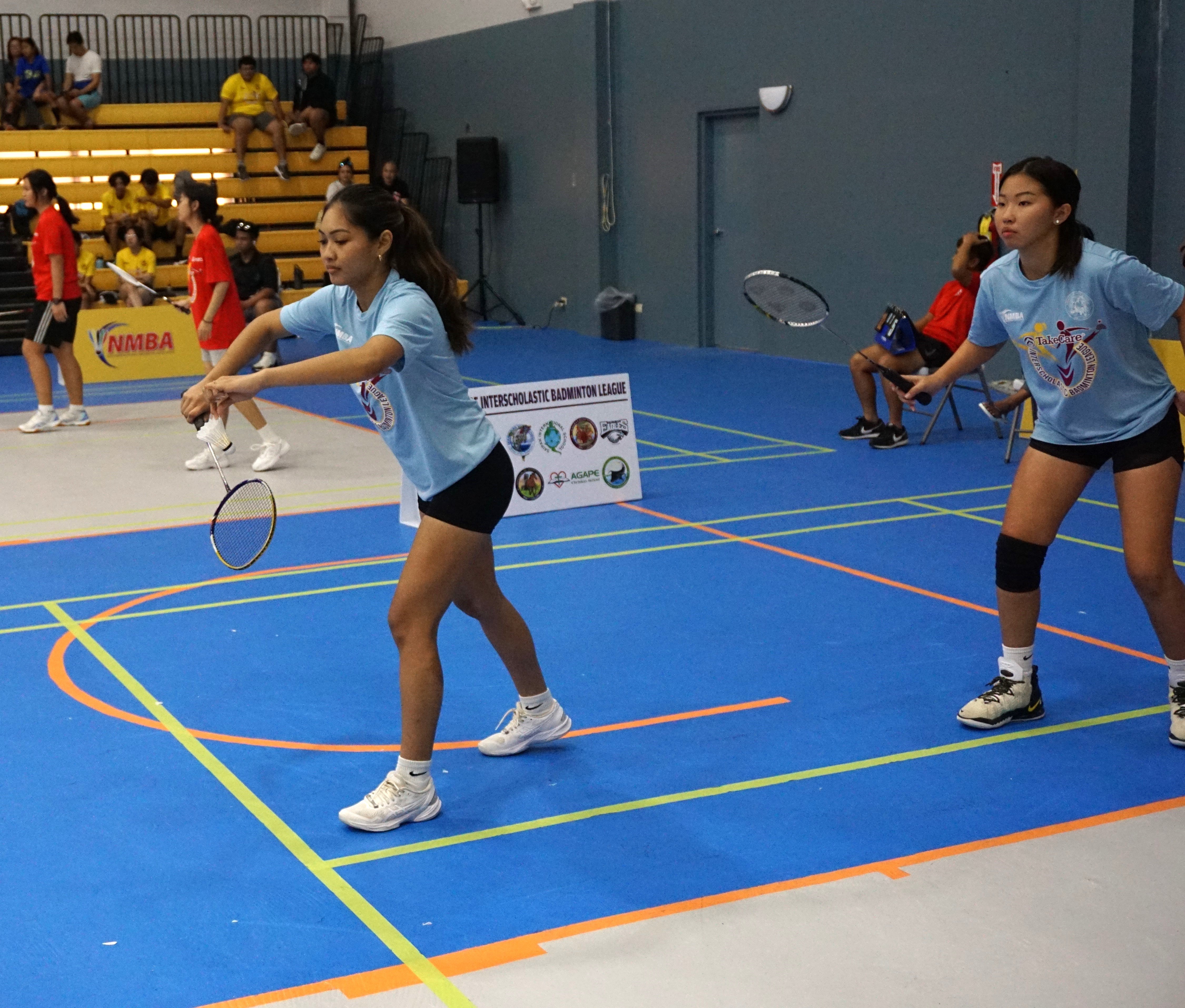 An SIS player prepares for the serve during a high school division game of the TakeCare-PSS Interscholastic Badminton League at the Ada gym.