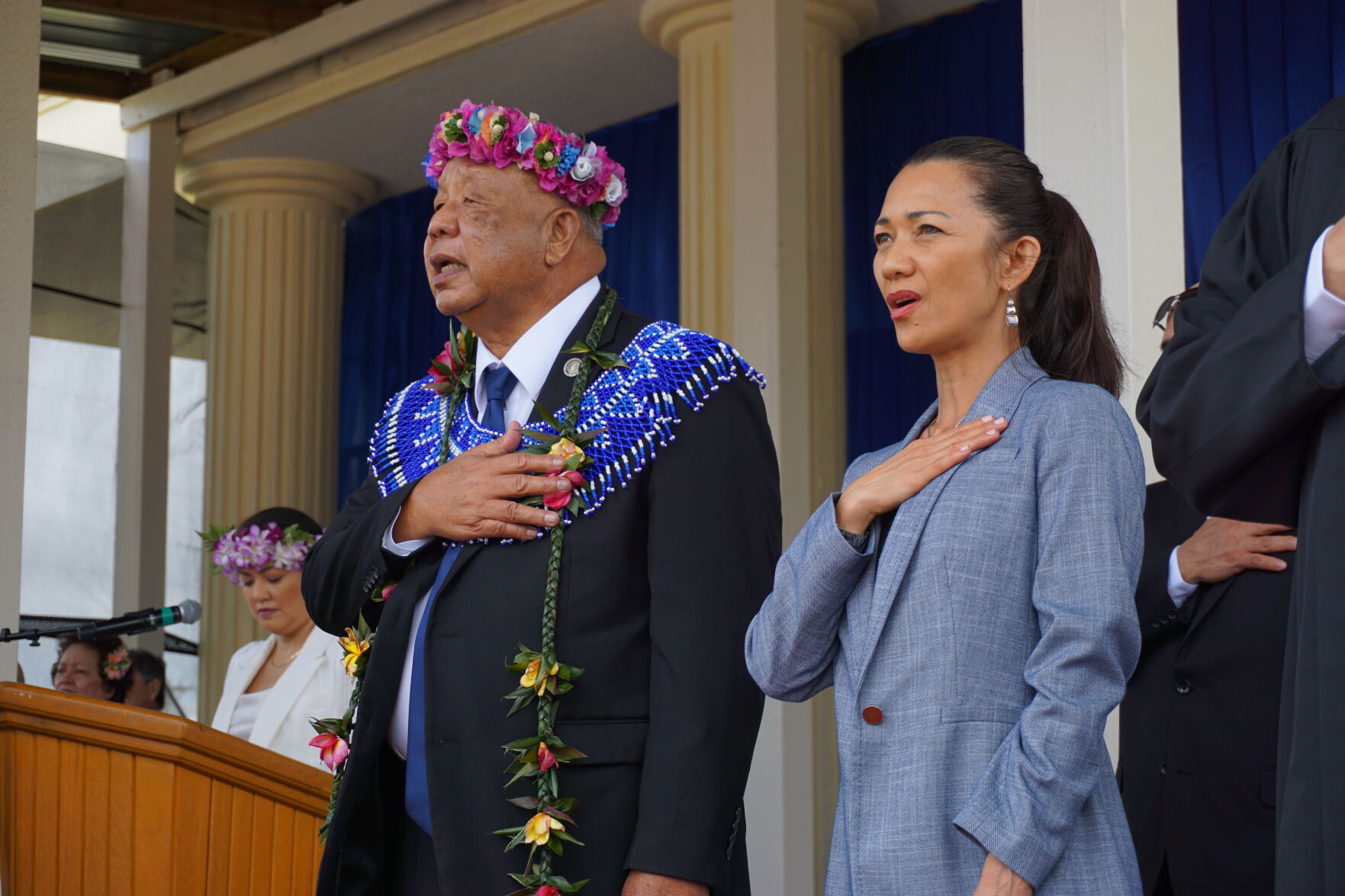 Lt. Gov. David M. Apatang and daughter Elaine place their right hands over their hearts as they sing the CNMI anthem.