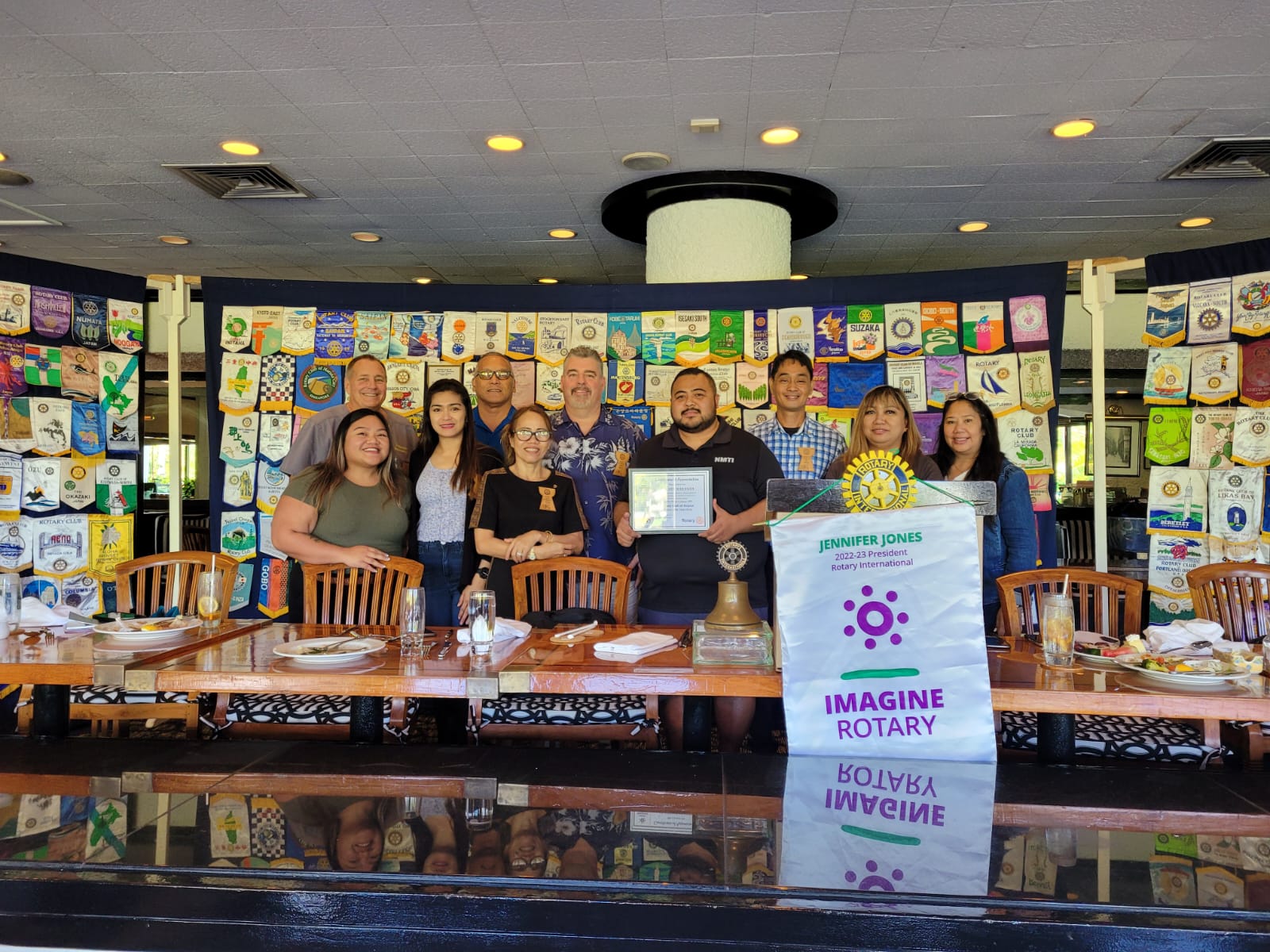 Northern Marianas Technical Institute Marketing Coordinator Ben Babauta Jr., fourth right, and Curriculum Director Margie Ray Santos, left foreground, pose for a photo with Saipan Rotary Club of Saipan President Wendell Posadas, third right, and other Rotarians after a presentation at the Hyatt Regency Saipan's Giovanni's Restaurant on Tuesday.