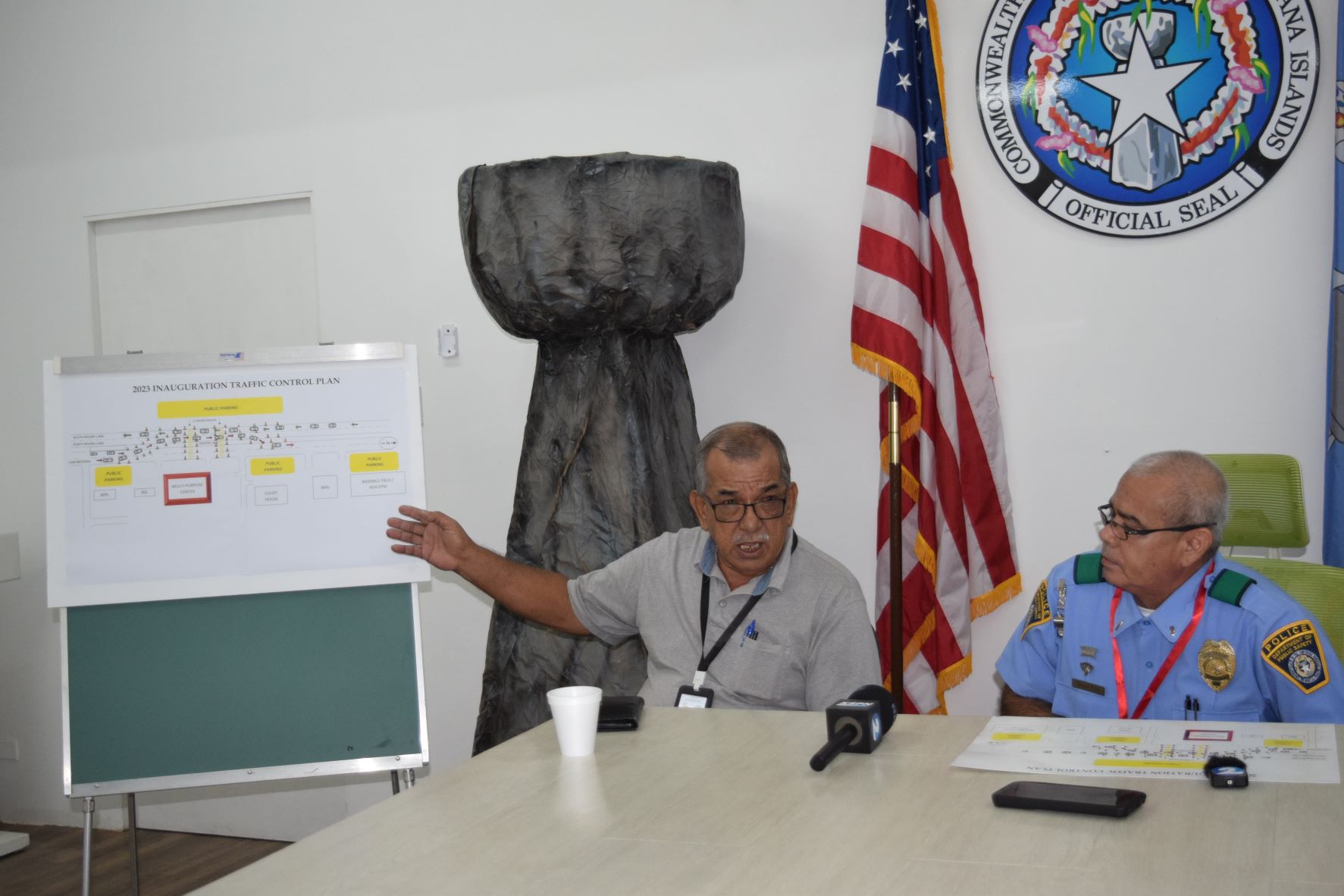 The inauguration subcommittee vice chairman, former Speaker Oscar M. Babauta, presents the  traffic control plan for the inauguration venue as Department of Public Safety Highway Patrol Lt. Dan Smith looks on.